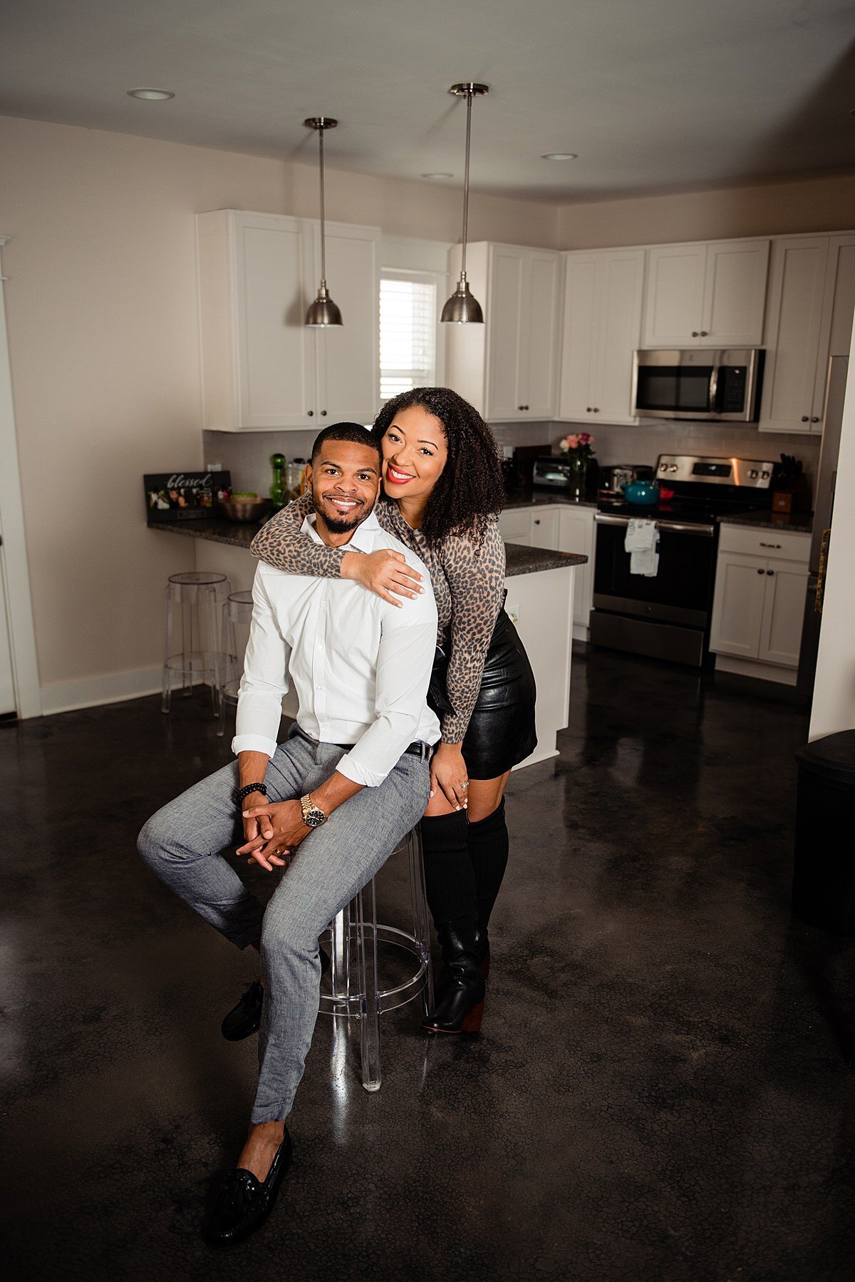 Jasmine Sweet with her husband in their new kitchen smiling at the camera