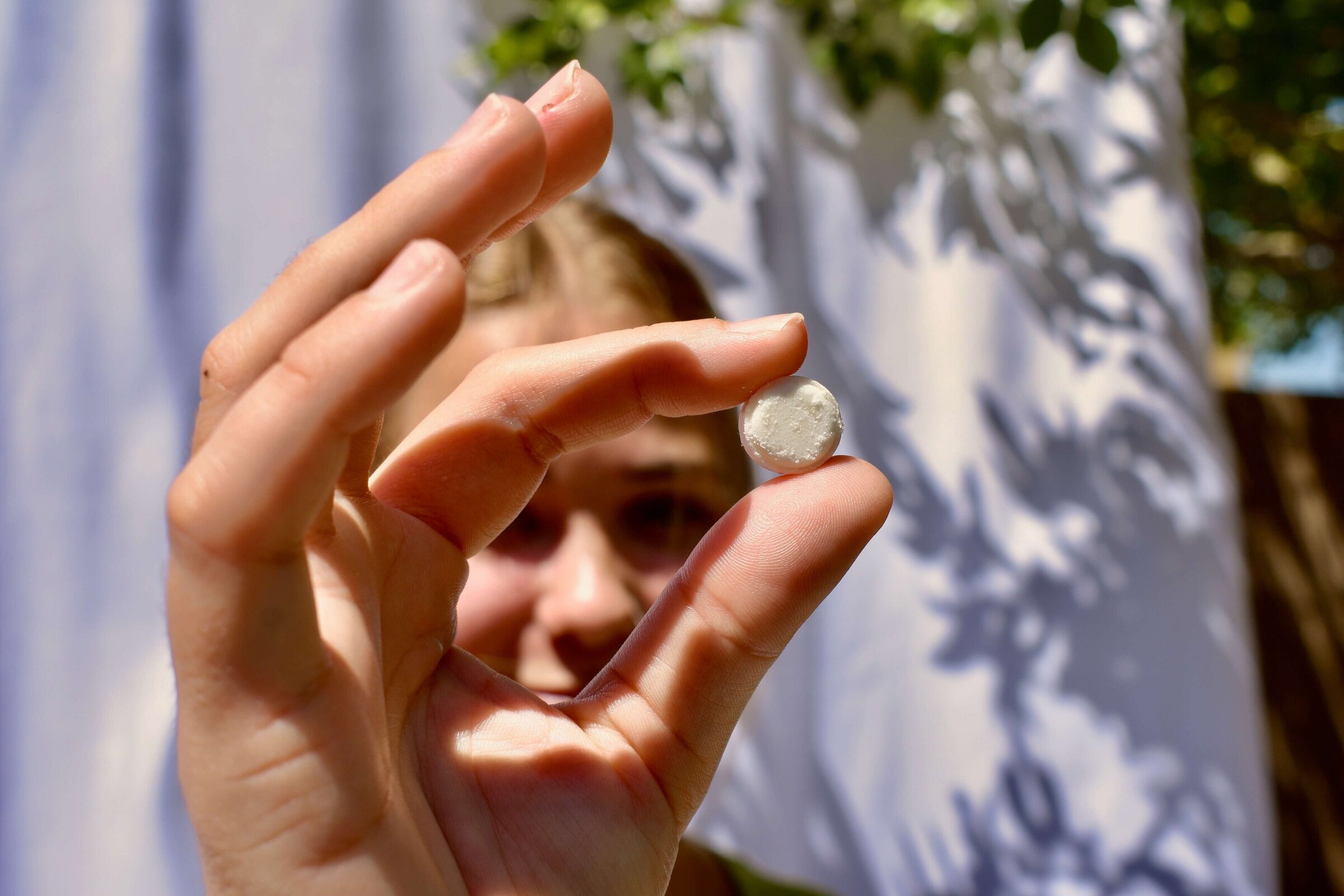 female using sustainable face wash tablet