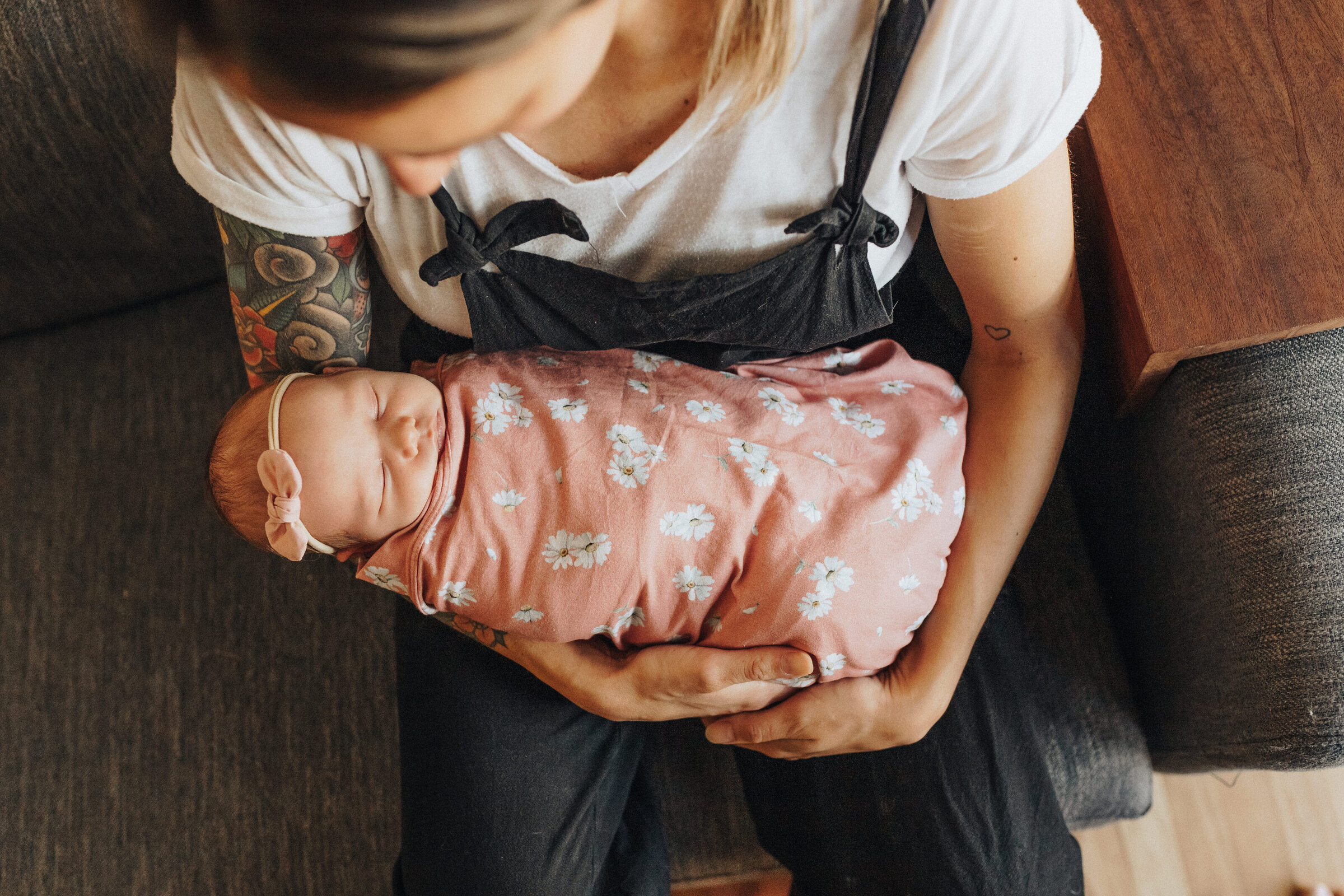 Mom holds swaddled newborn baby