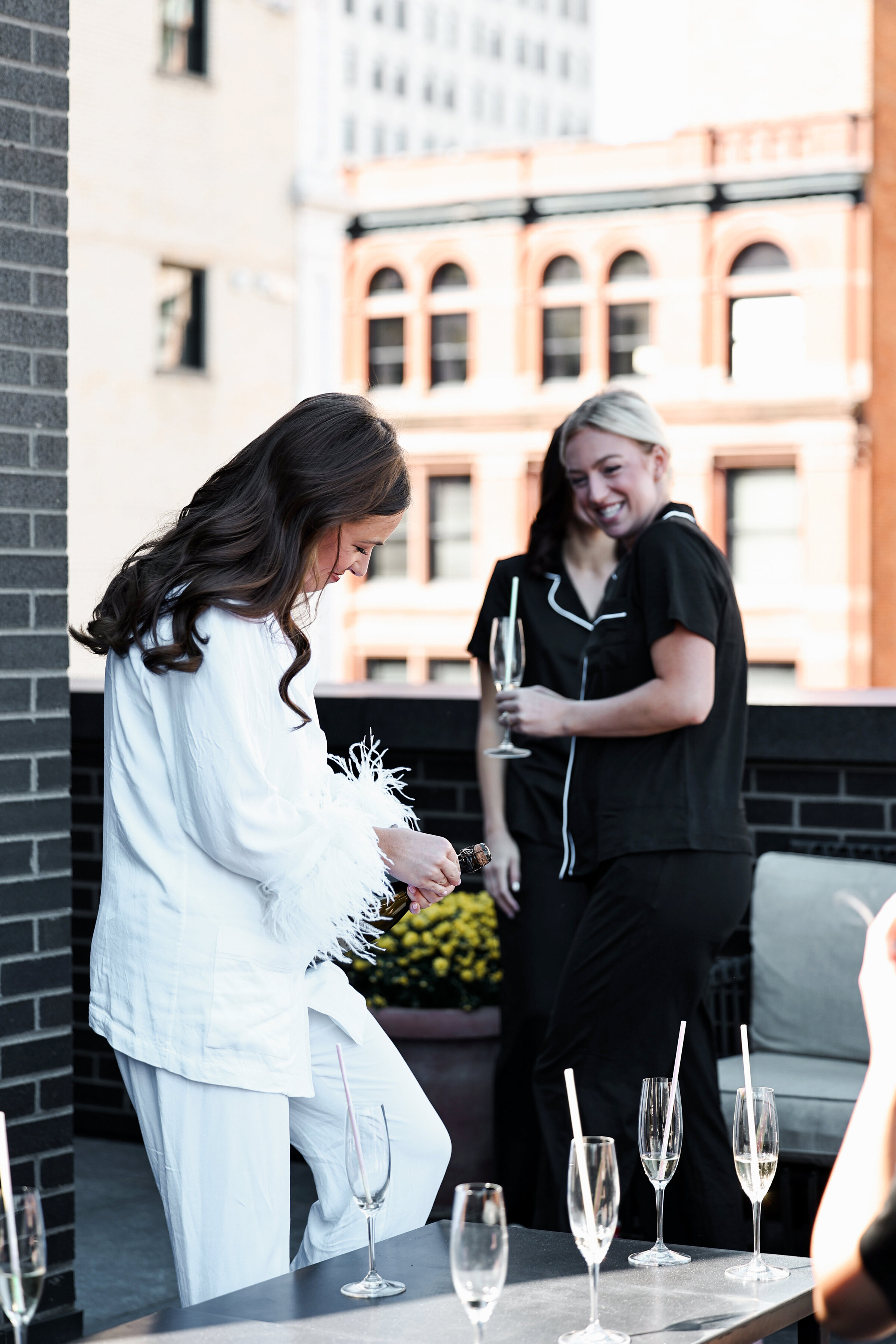 Bride getting ready for her champagne toast in detroit shinola hotel on the rooftop.  