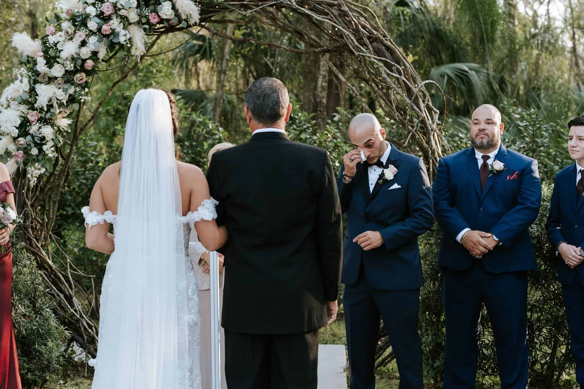 Groom wiping away tears at the wedding ceremony at a Tampa Wedding venue