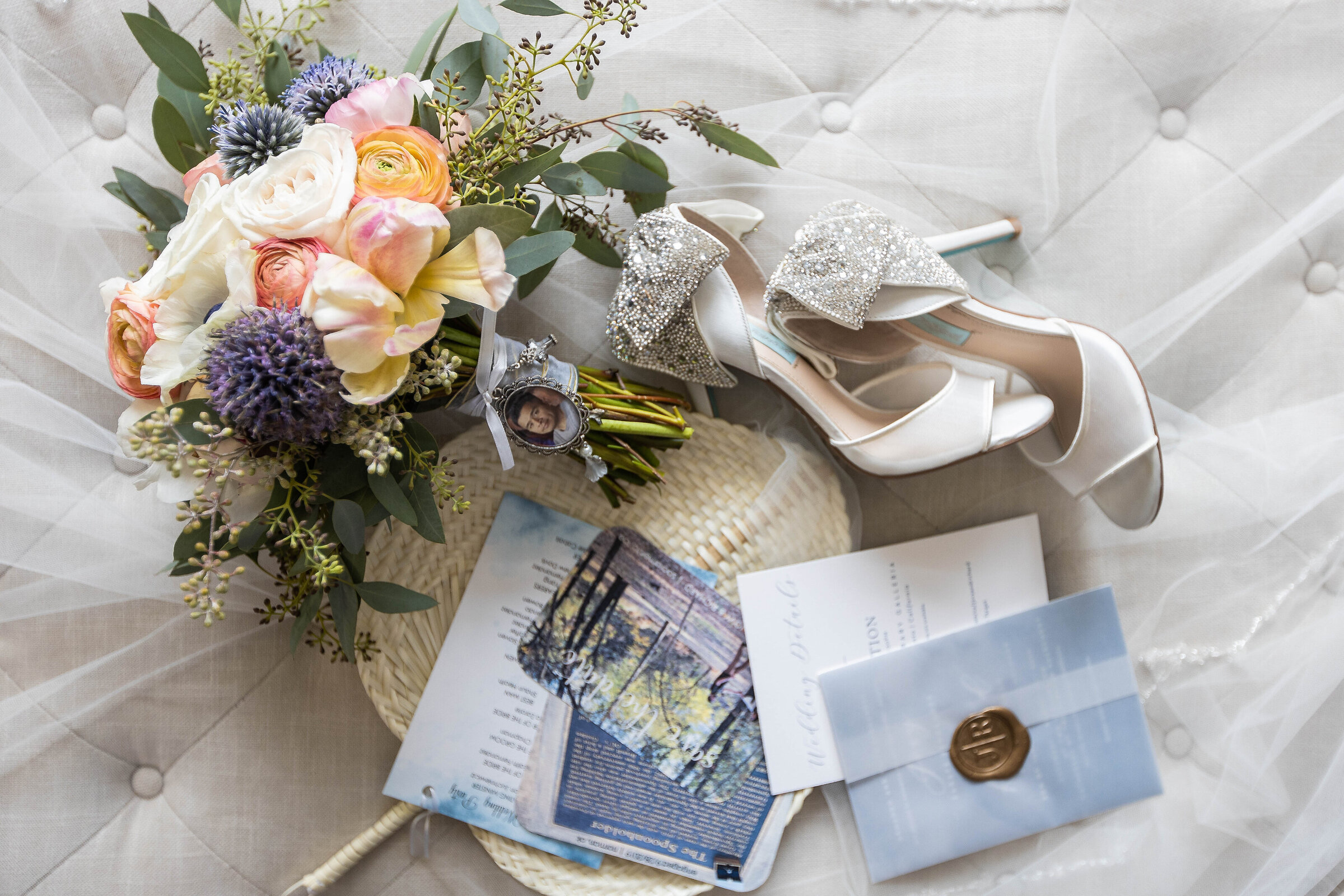 Flat lay of wedding details including shoes, invitations and flower bridal bouquet by sacramento wedding photographer, philippe studio pro