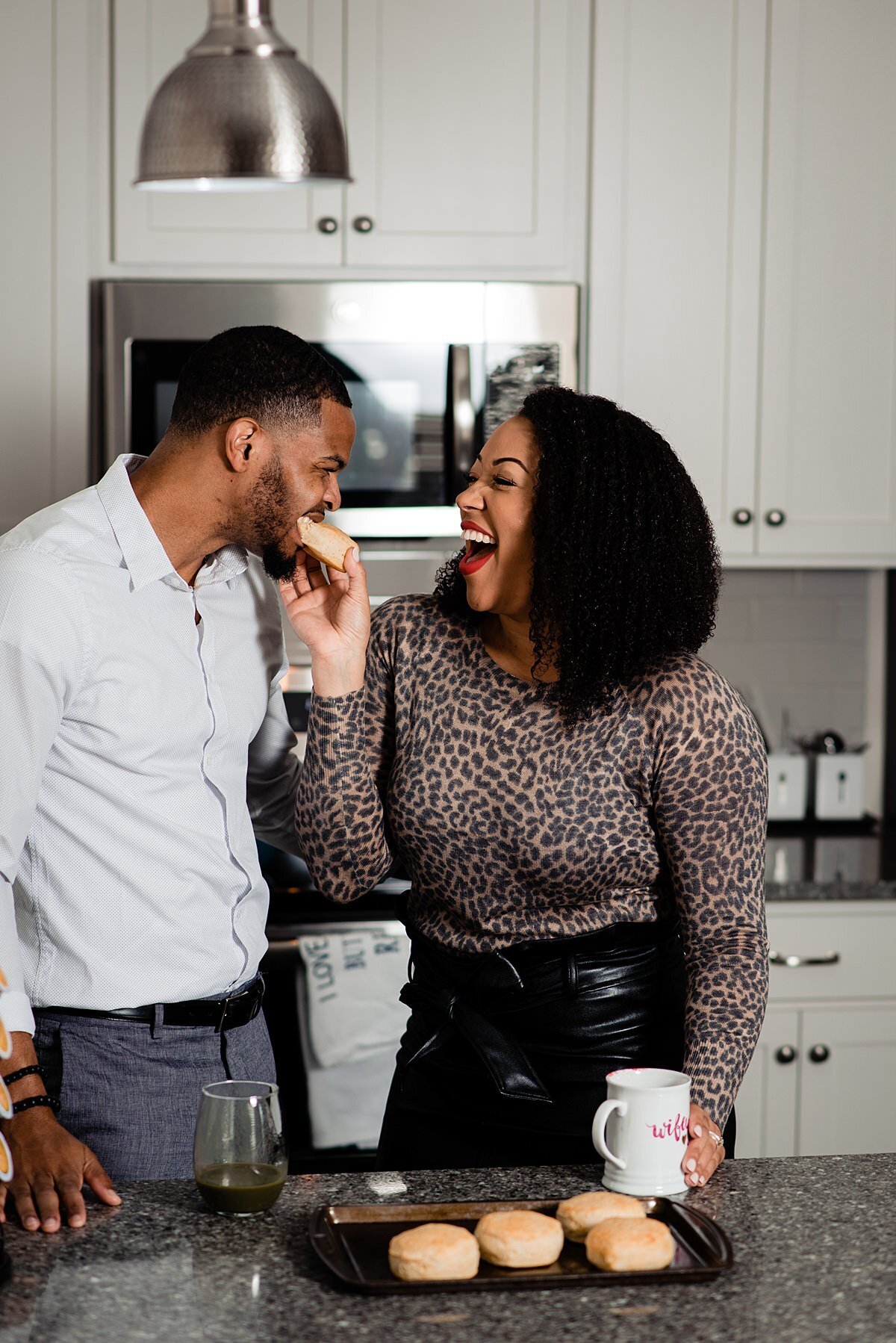 Candid moment of Jasmine Sweet feeding her husband a biscuit in the kitchen of their new house