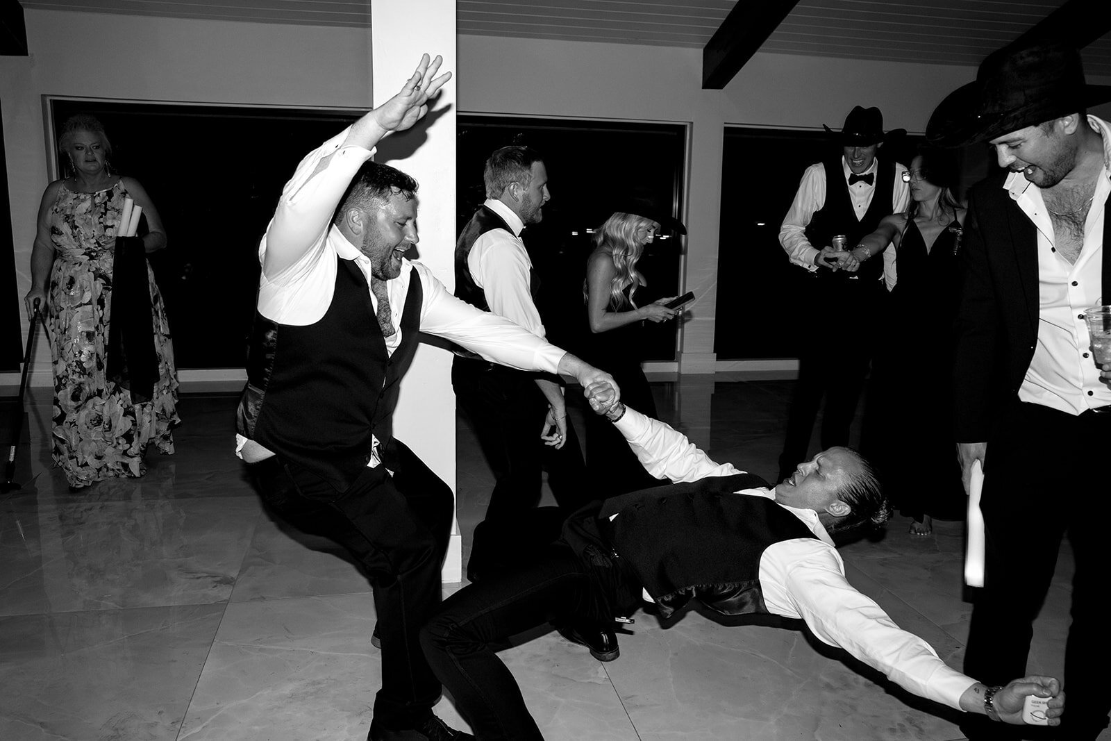 Guests dancing at the reception, having the time of their lives. 