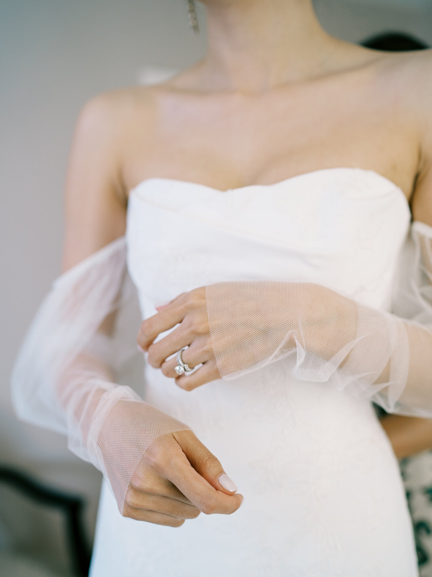 brides hands with off the shoulder sleeves