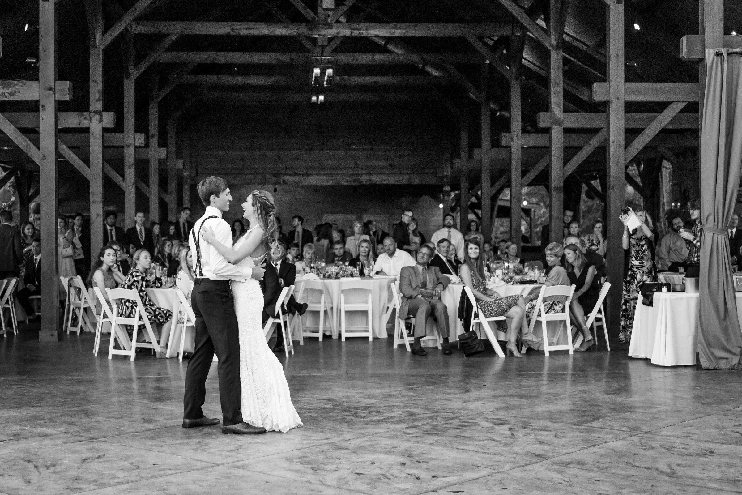 Ohio groom shares first dance with his bride on their wedding day, surrounding by all their friends and family. Photo taken by Aaron Aldhizer