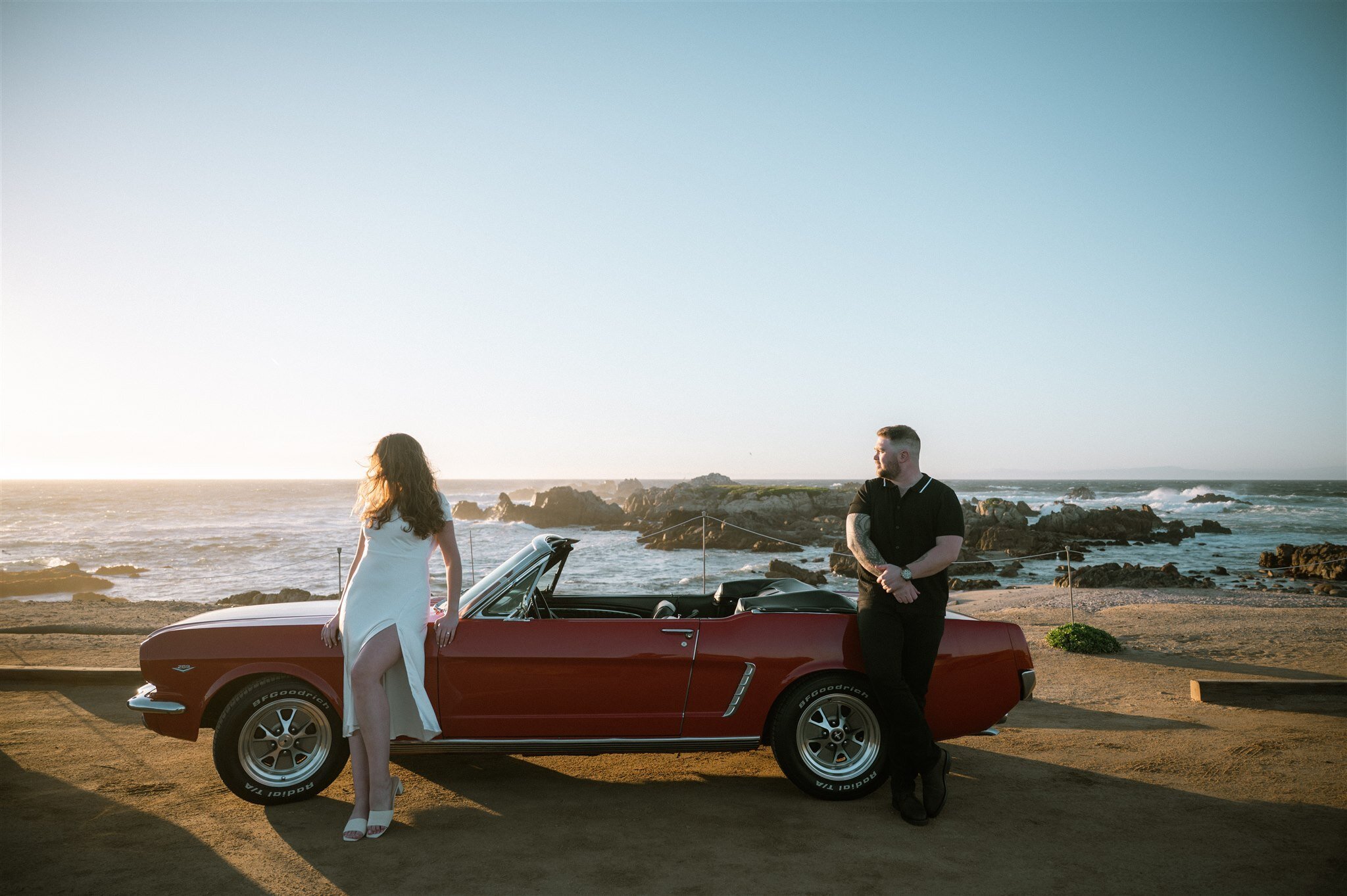 Monterey couple’s session featuring an old Ford convertible rental at sunset by the ocean