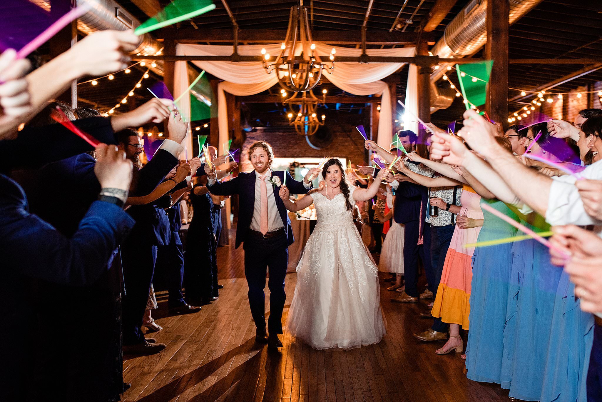 Grand exit at the end of the wedding night inside of Cannery ONE with guests waving glowsticks