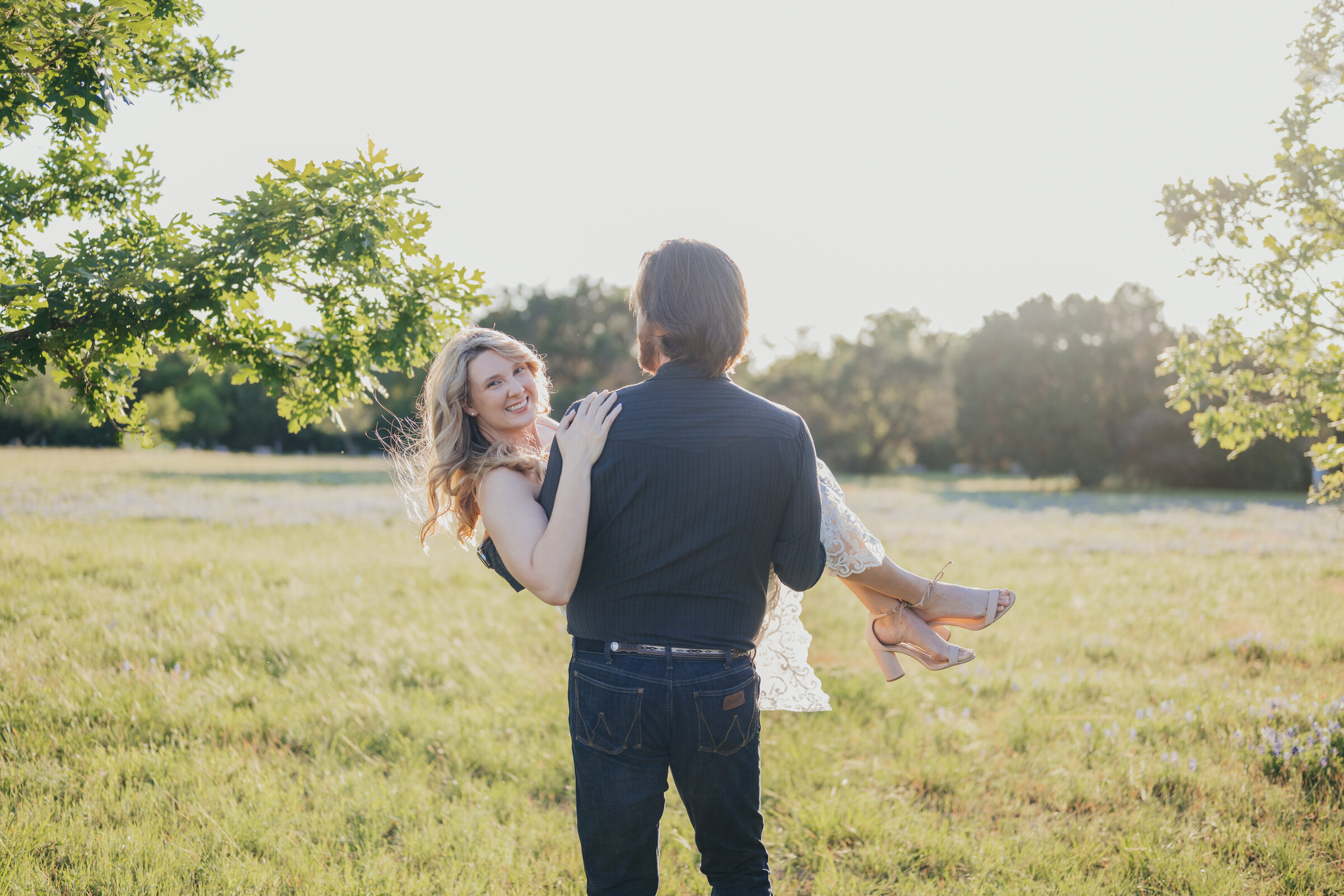 boy-carrying-girl-through-field