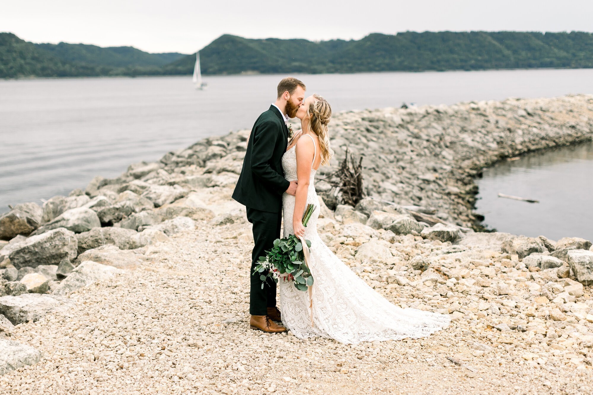 Bride and groom kissing on a beach, taken by wedding photographers minneapolis