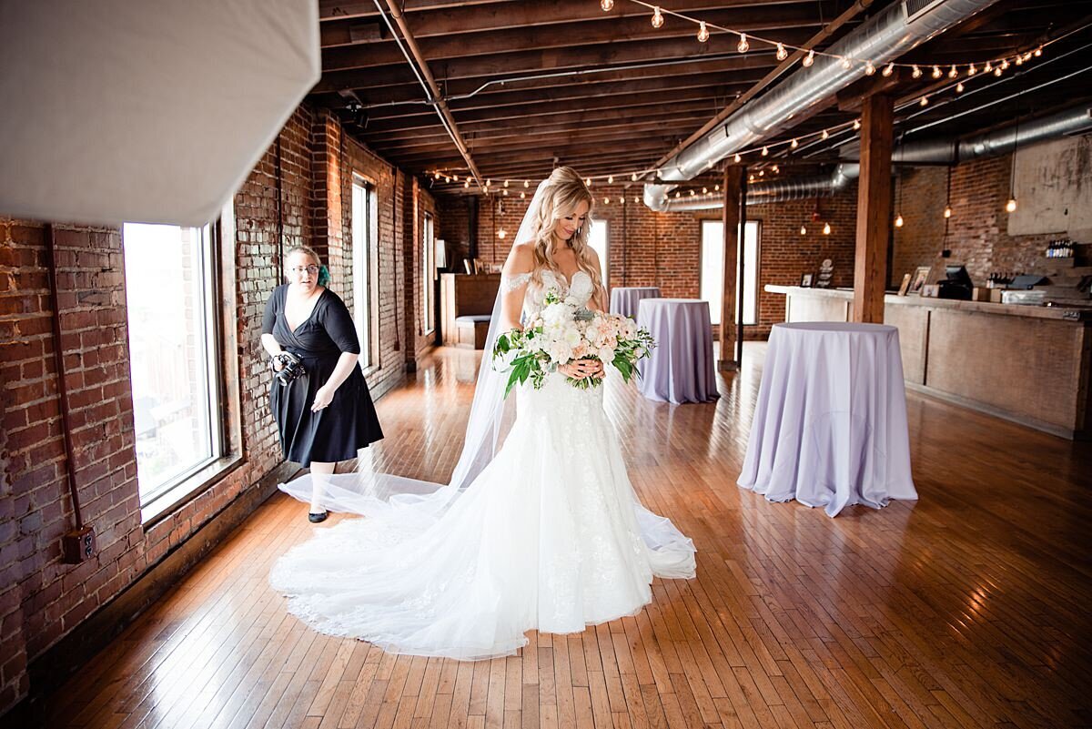 Mahlia helping the bride with her veil inside of Cannery ONE
