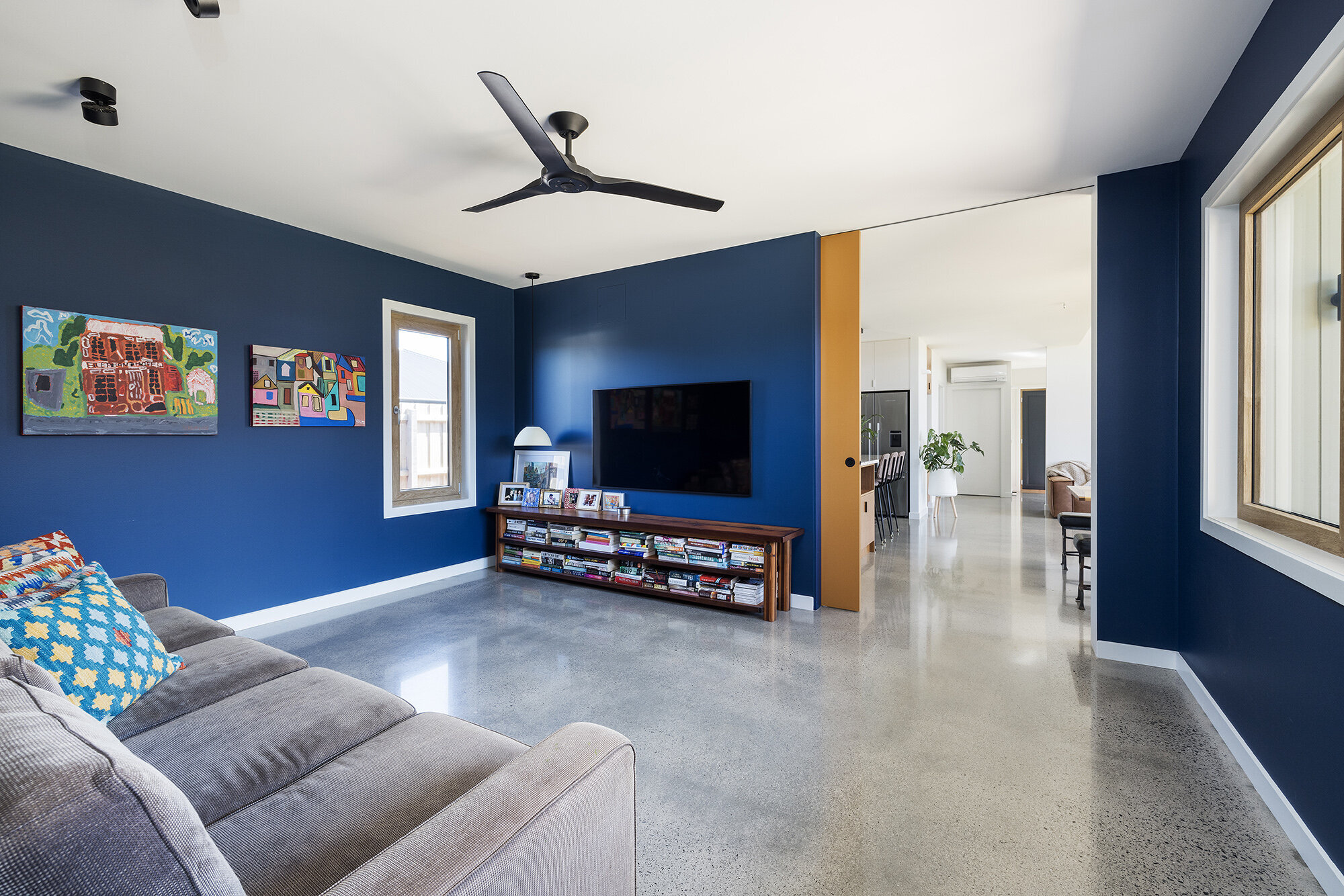 BLUE ROOM WITH POLISHED CONCRETE FLOOR SQUARE SET CEILING
