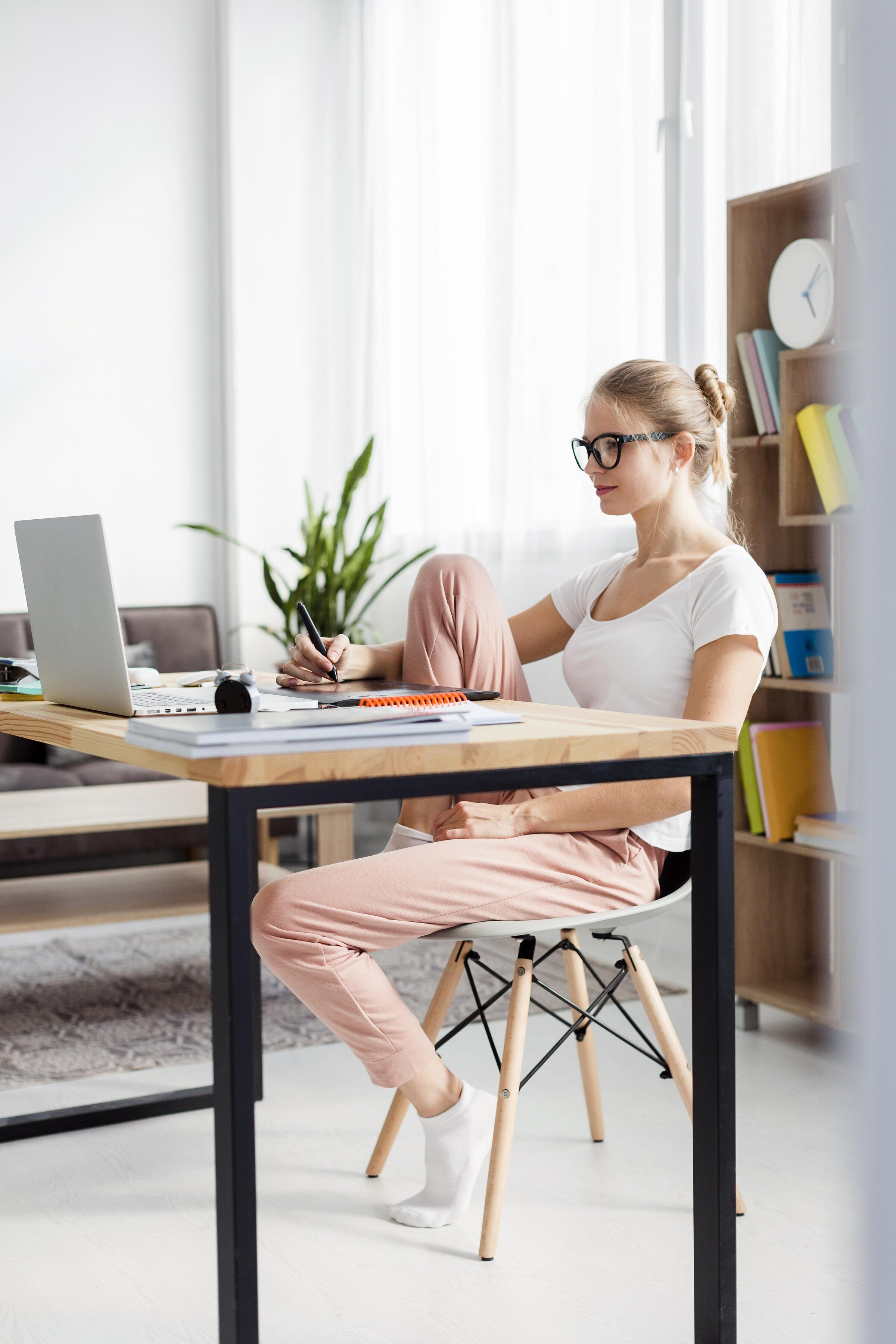 side-view-woman-desk-working-while-home