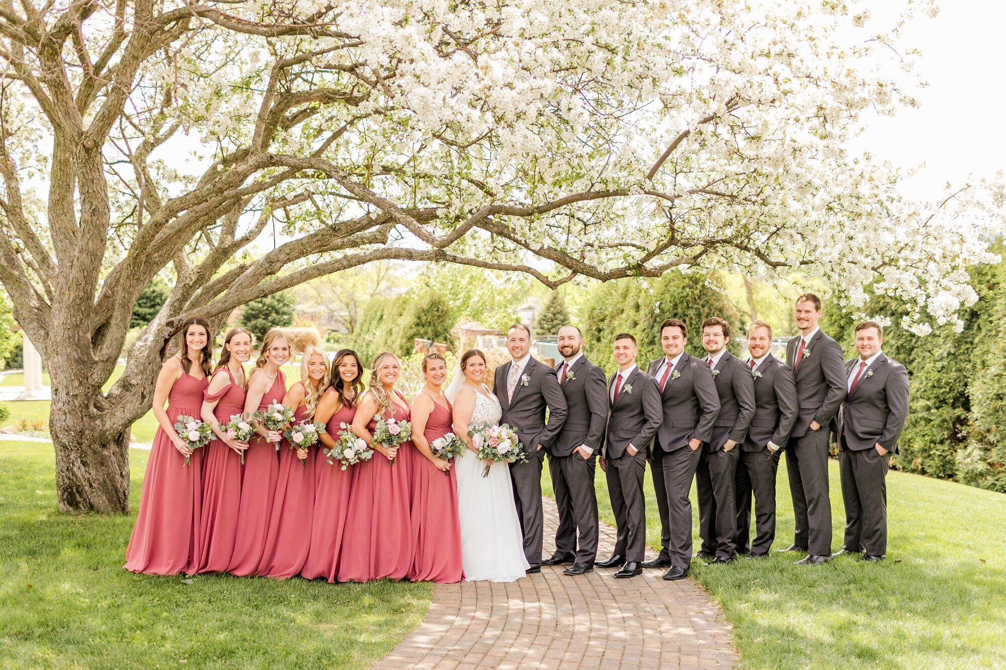 Bridal party wearing black and red on a path, taken by wedding photographer minneapolis mn
