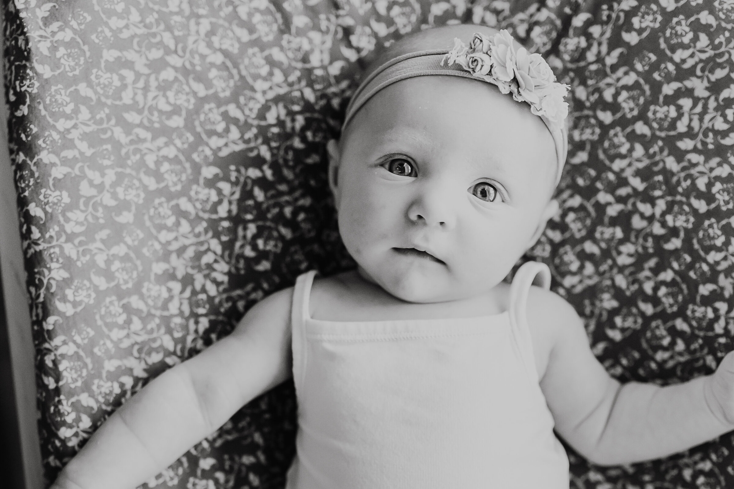 Black and White Photo of Baby looking at Camera