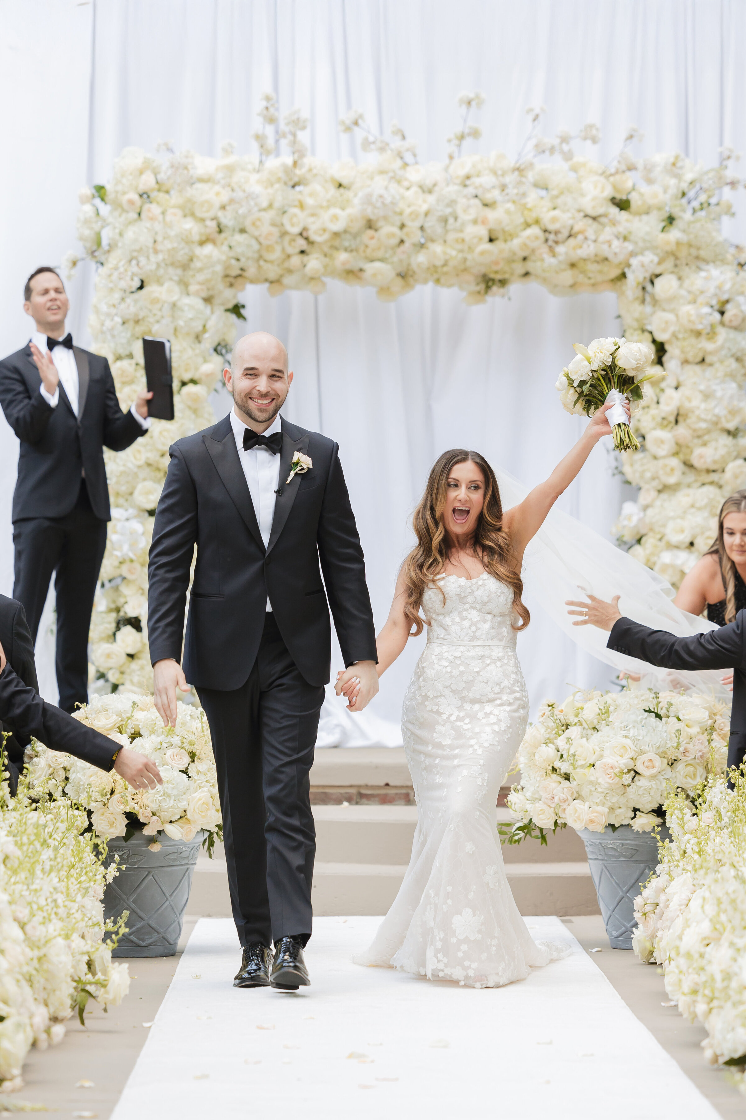 Luxury outdoor wedding ceremony at Vie by Cescaphe in Philadelphia featuring elegant white floral arrangements and lush greenery