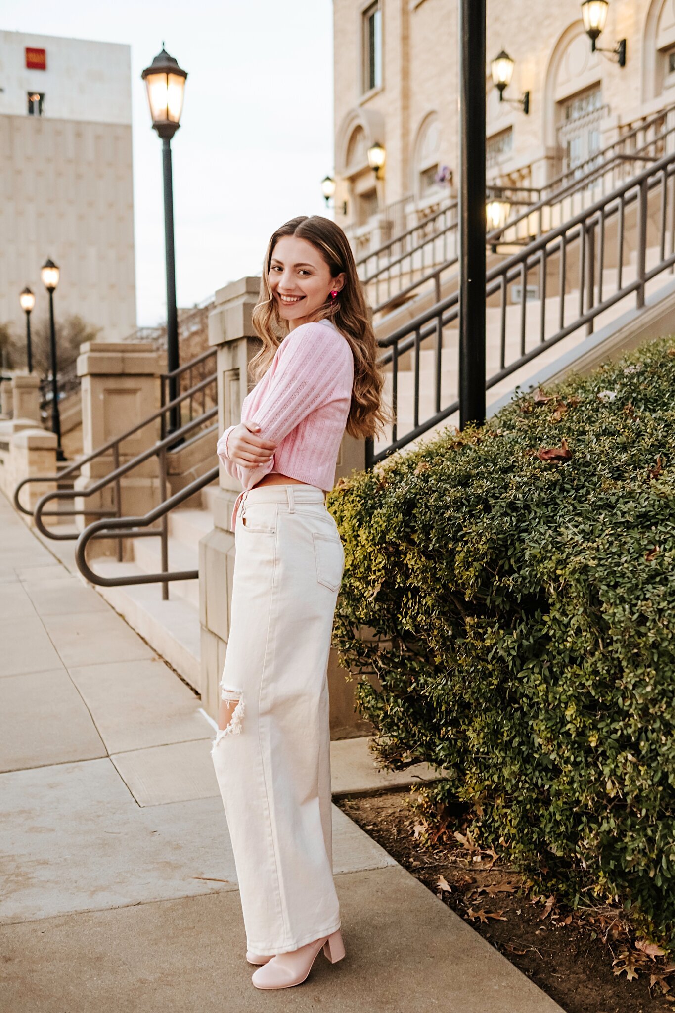 Seattle college senior photoshoot, she is laughing at the camera and wearing a pink cardigan and pants from Target