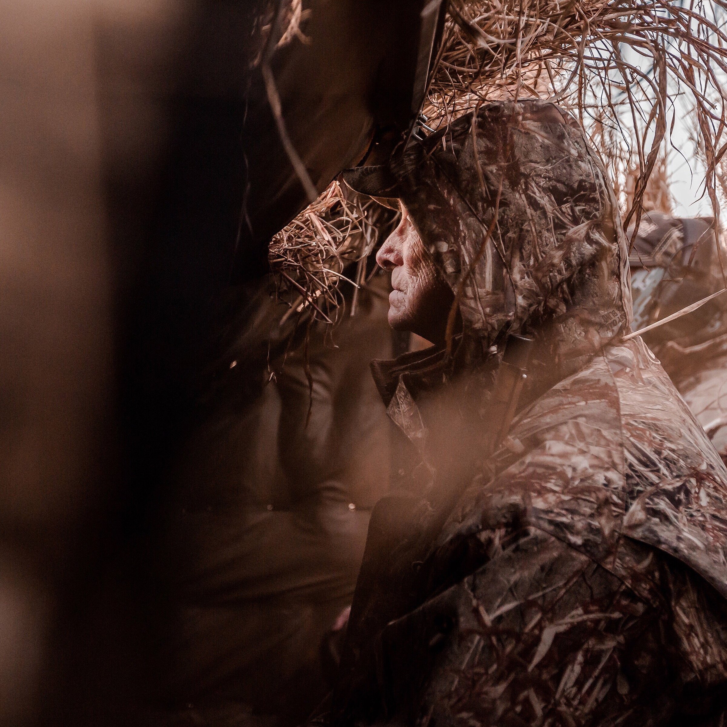 Kansas waterfowl hunter looking out a blind