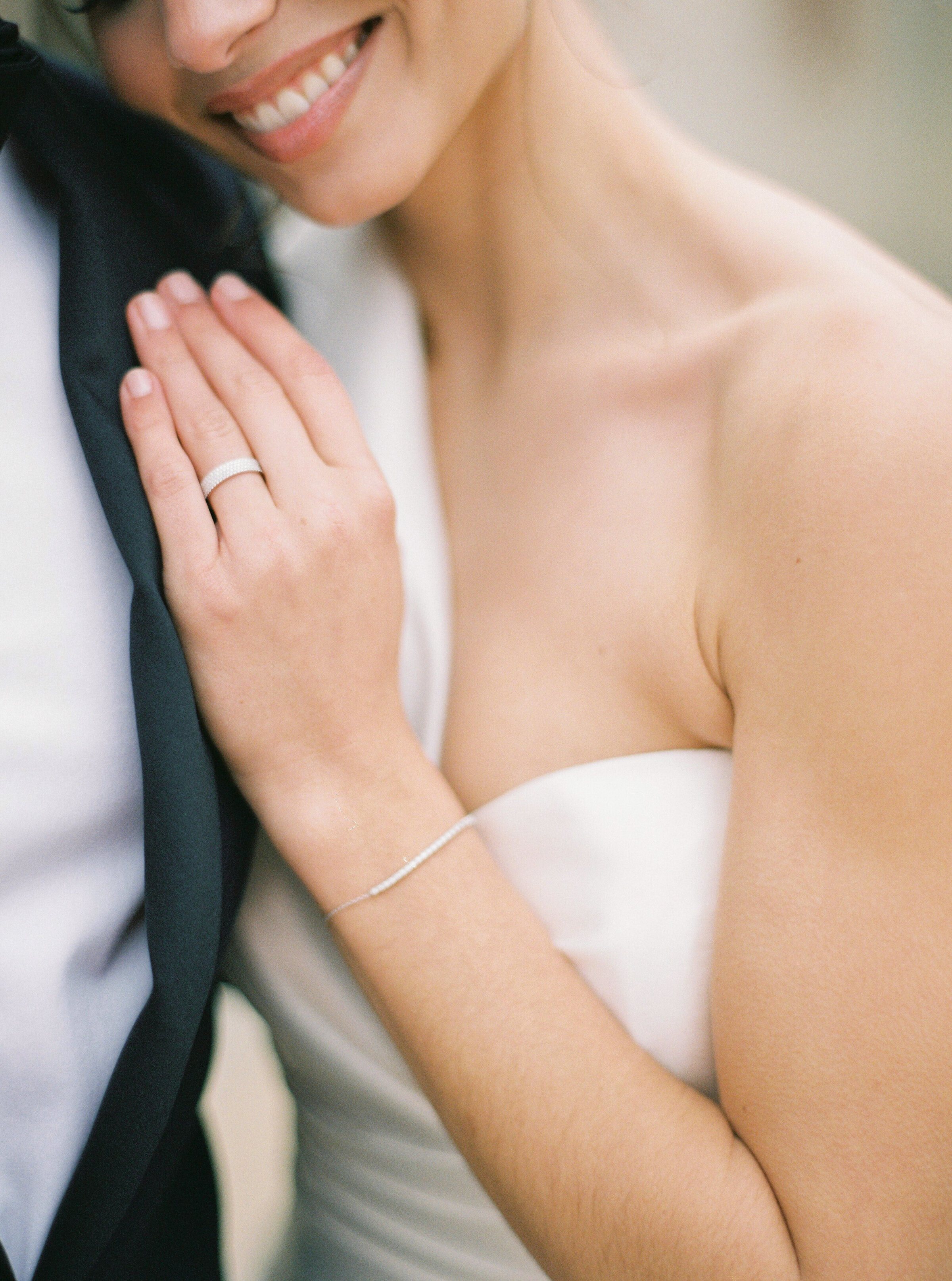 close up of bride in her groom arms