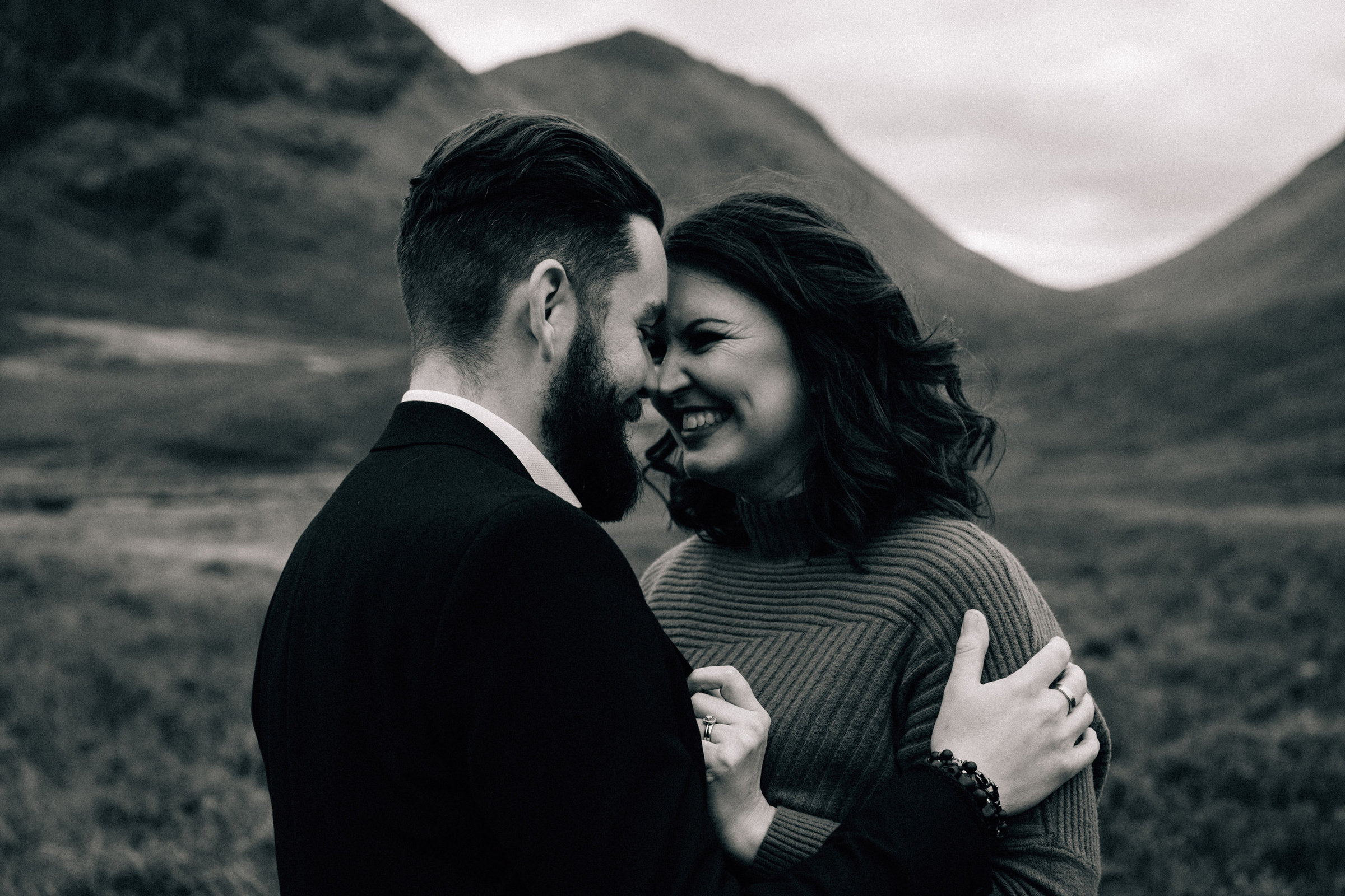 Smiling couple showing off their wedding rings during their elopement in Glencoe Scotland