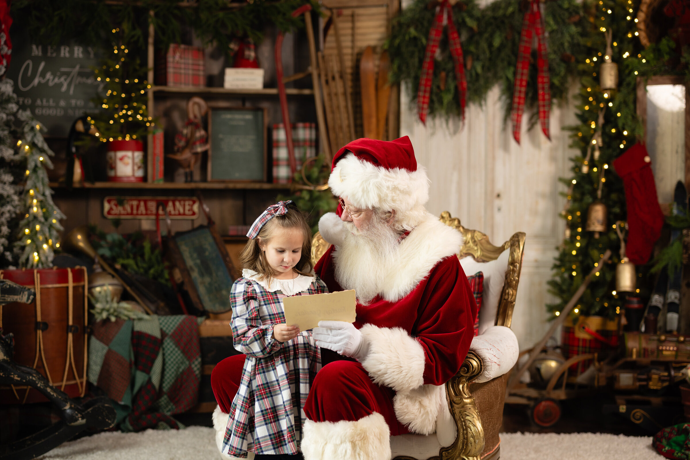 Santa sitting with a young child in the studio during a Christmas photo session in Canton, GA