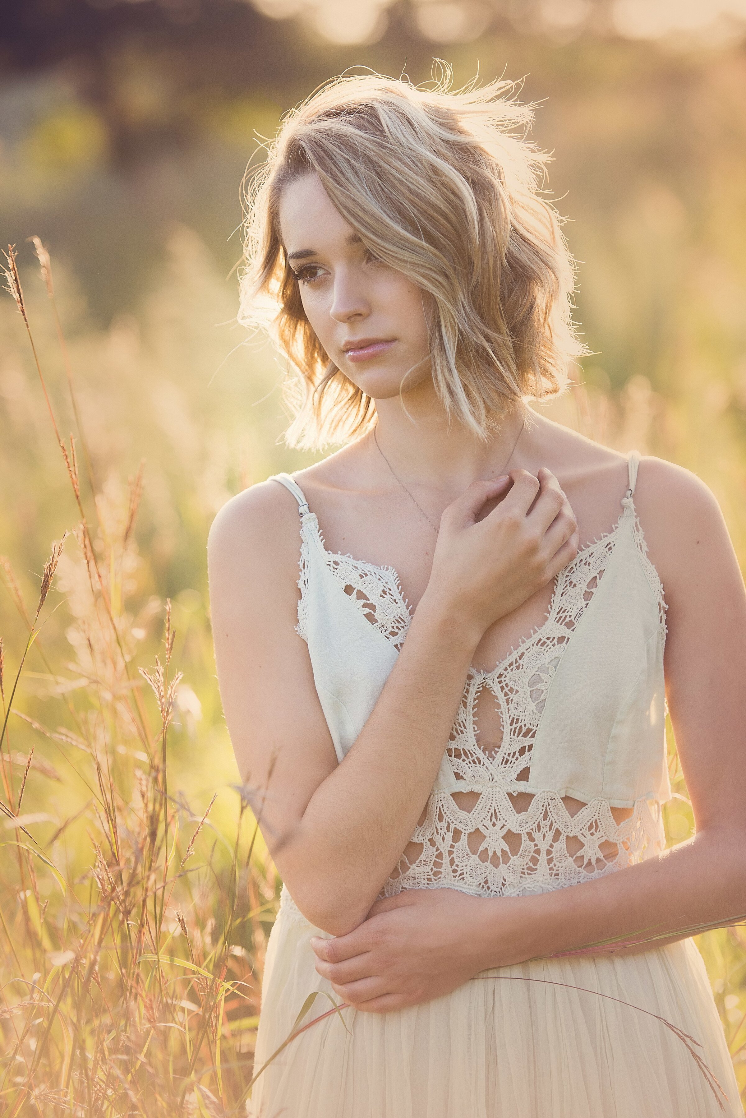 Chaska Minnesota high school senior photo of girl in minnesota in long grasses in white dress in prairie dress