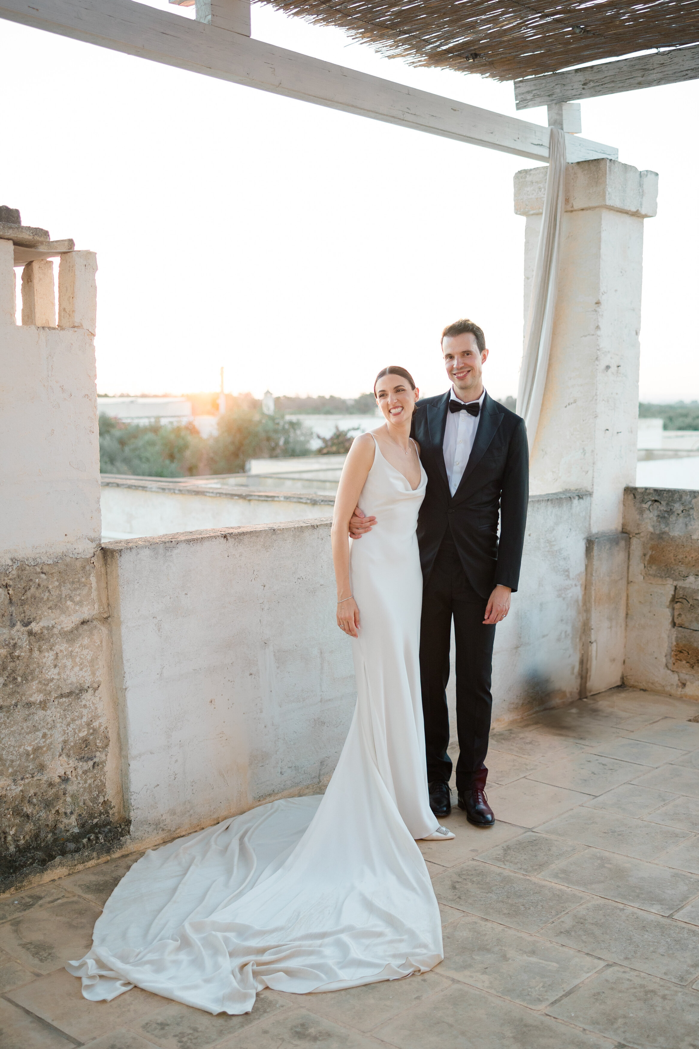 Wedding and Elopement Photographer, bridal couple standing on roof top during sunset