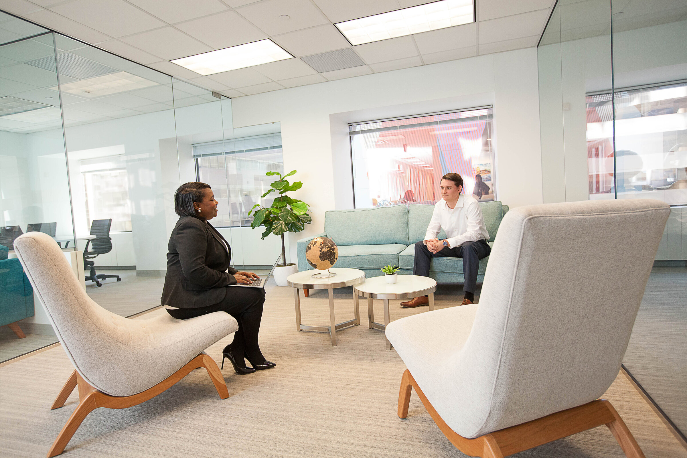 Corporate room with two people sitting in waiting area