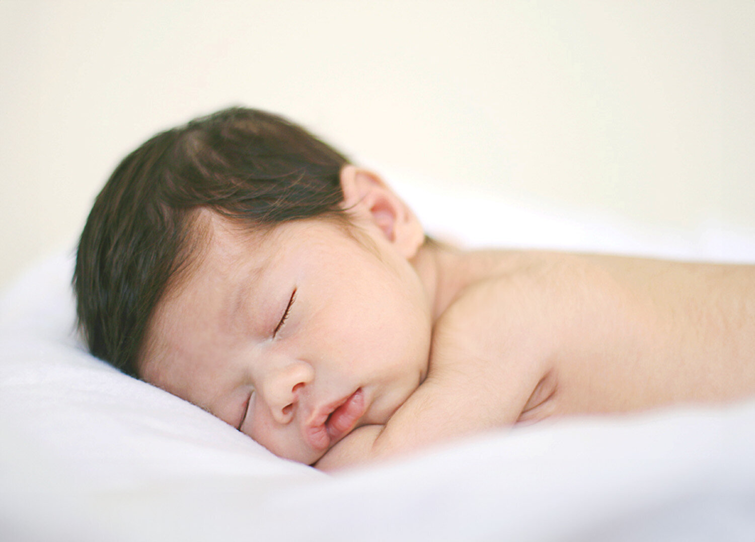 Close-up of newborn baby boy laying on stomach, captured by San Francisco Bay Area natural newborn photographer.