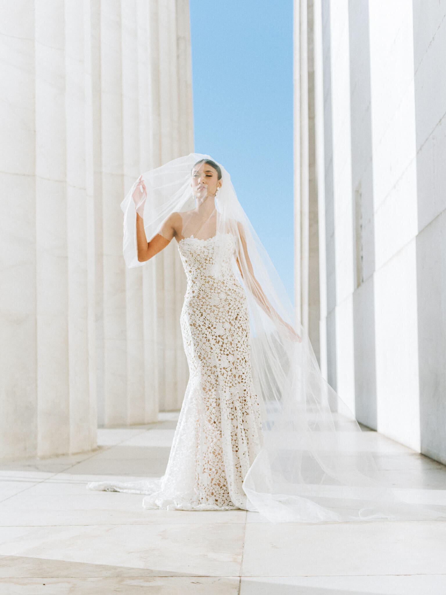 Bride wearing a Monique Lhuillier wedding gown at the Lincoln Memorial
