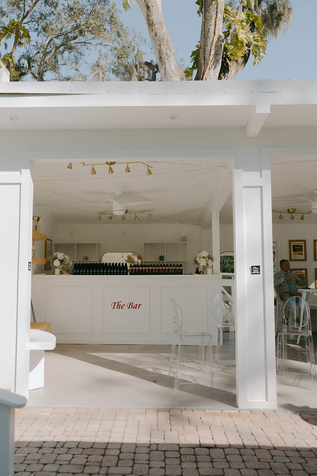 Modern white bar and indoor reception space at Uliana Estate in Lakeland, Florida, with gold accents and minimalist decor

