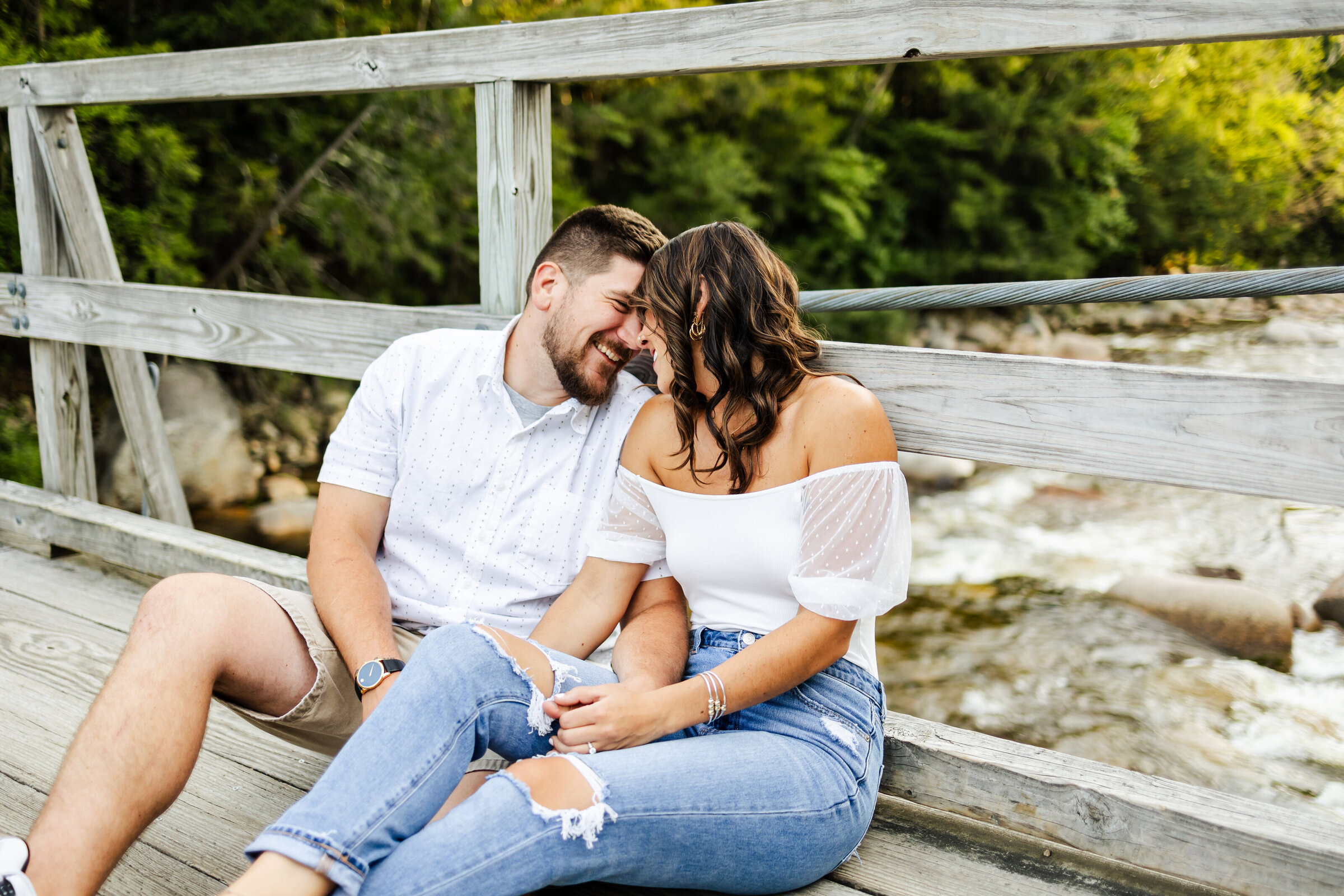 Engagement session in Lincoln, New Hampshire bride and groom nuzzle and laugh