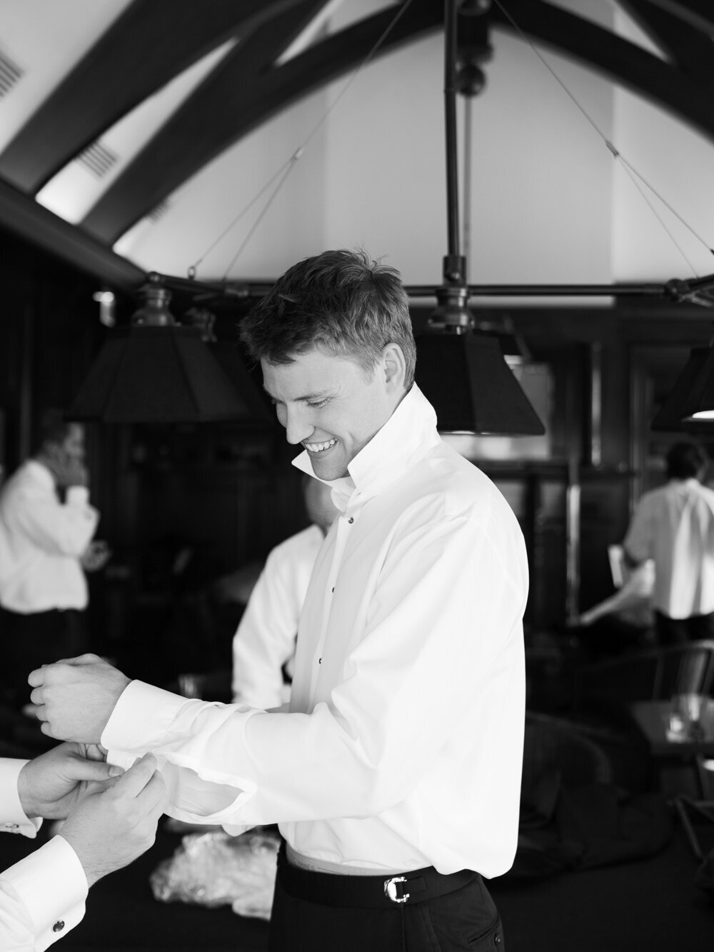 bw image of groom getting ready in the wooly toad room