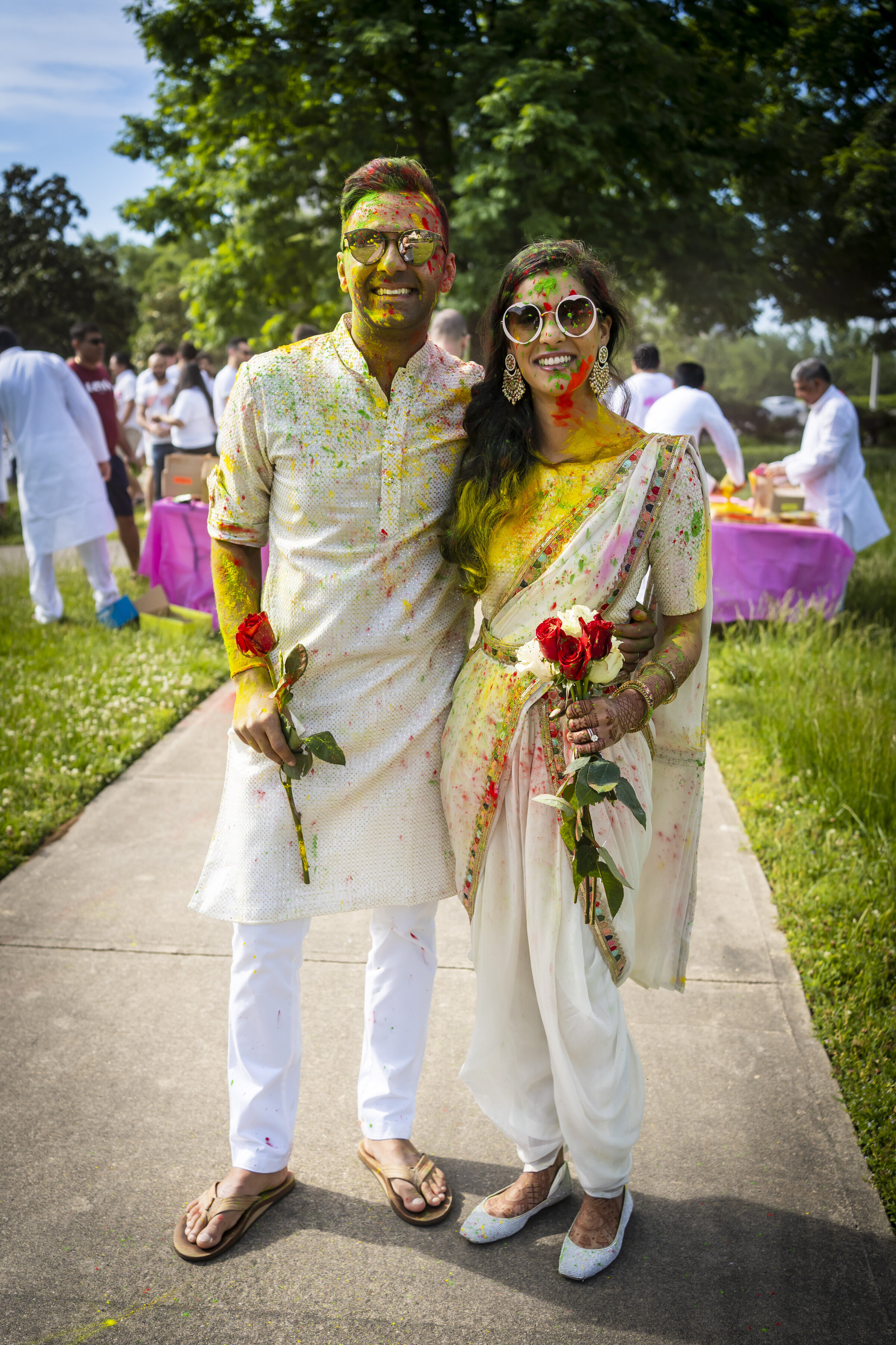 Indian couple covered with colorful powder.