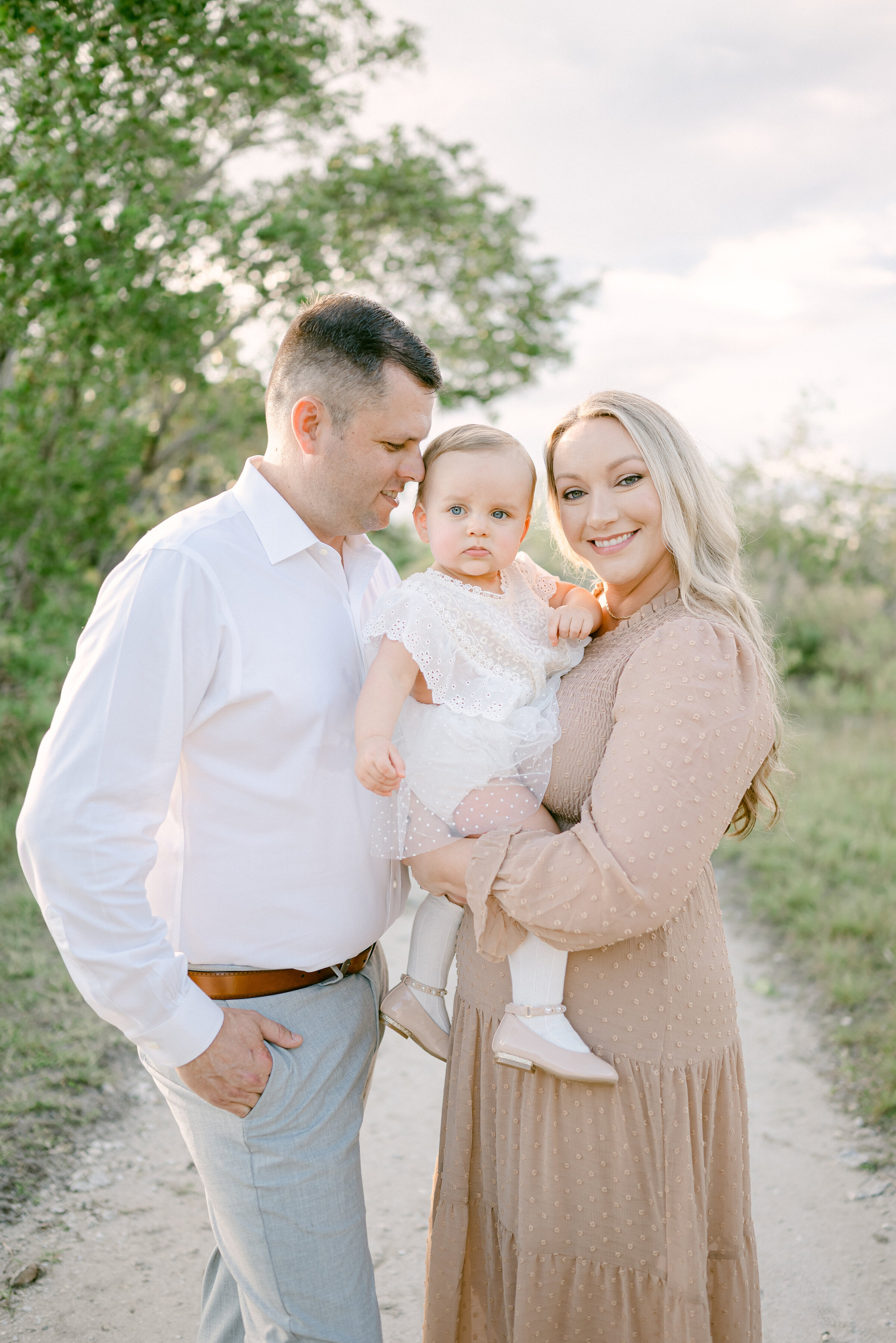 Family of three portrait in a park by Miami Family Photographer