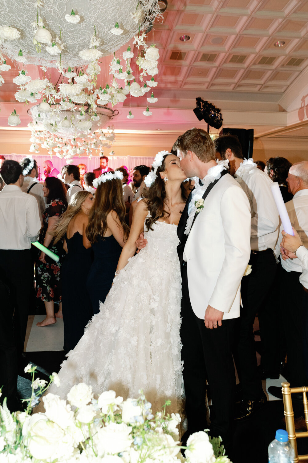 bride and groom kiss during reception dance party