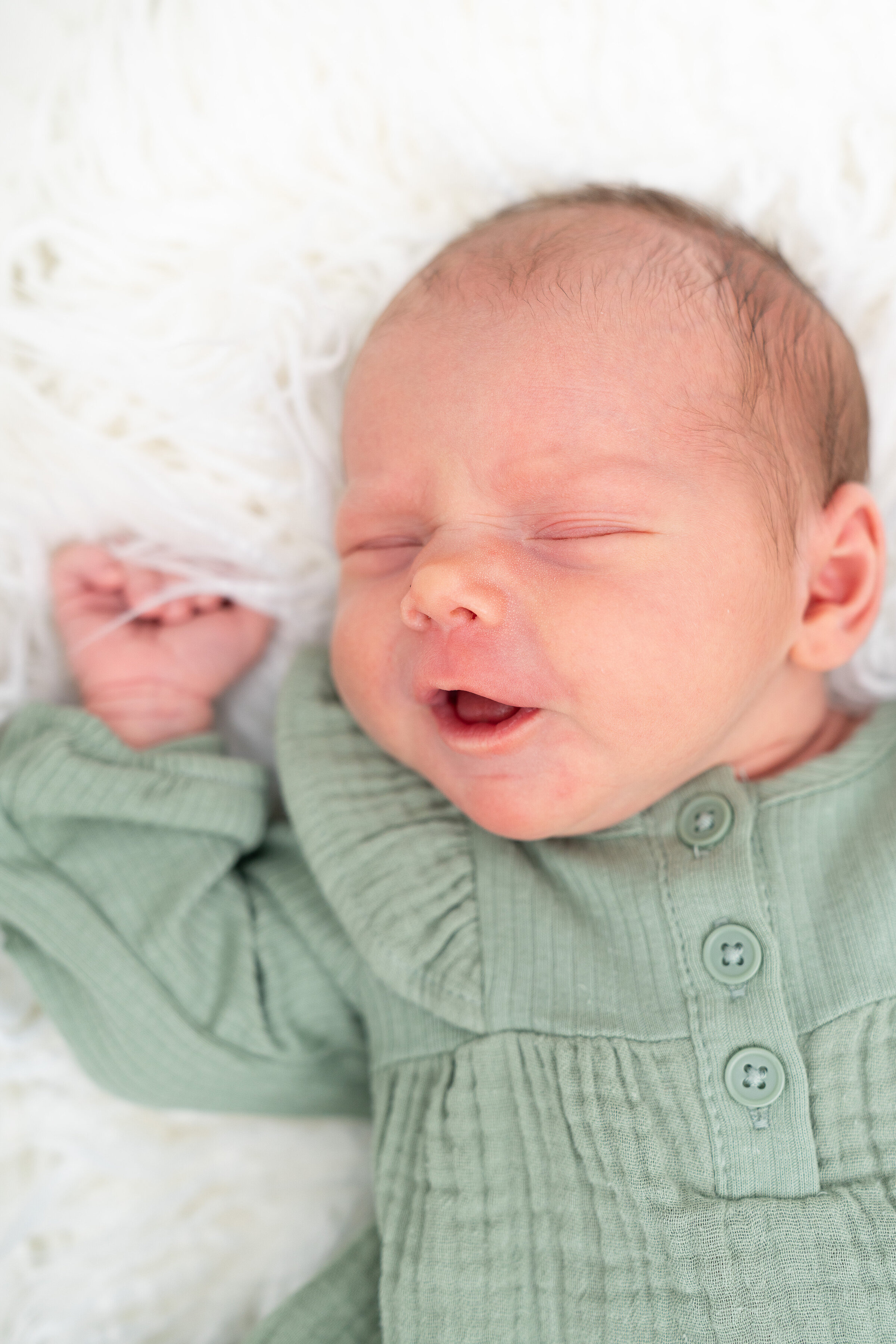 Newborn baby girl smiling in her sleep