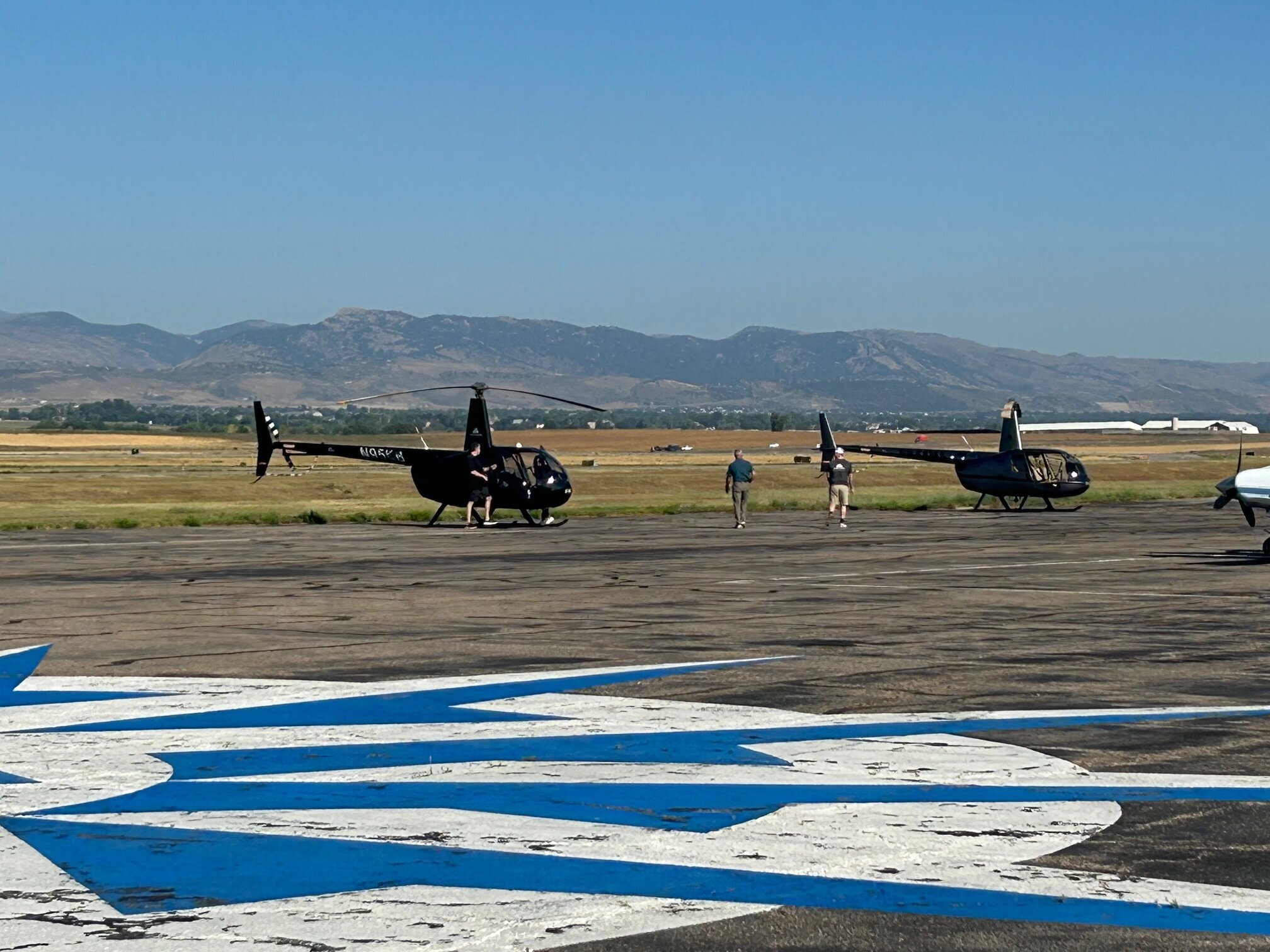 two front range heli helicopters with rocky mountains in background
