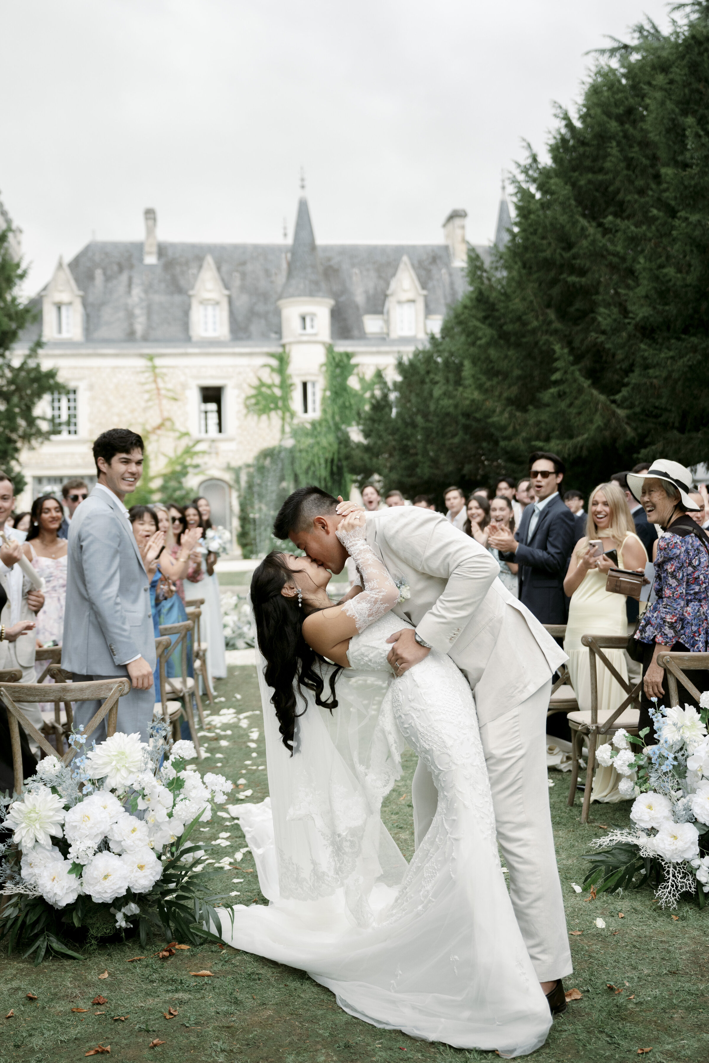 bride and groom at ceremony in front of chateau in France