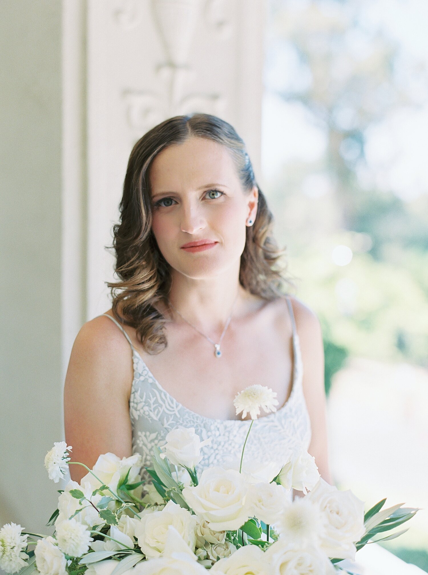 bridal portrait in light blue leanne marshall gown holding white flowers