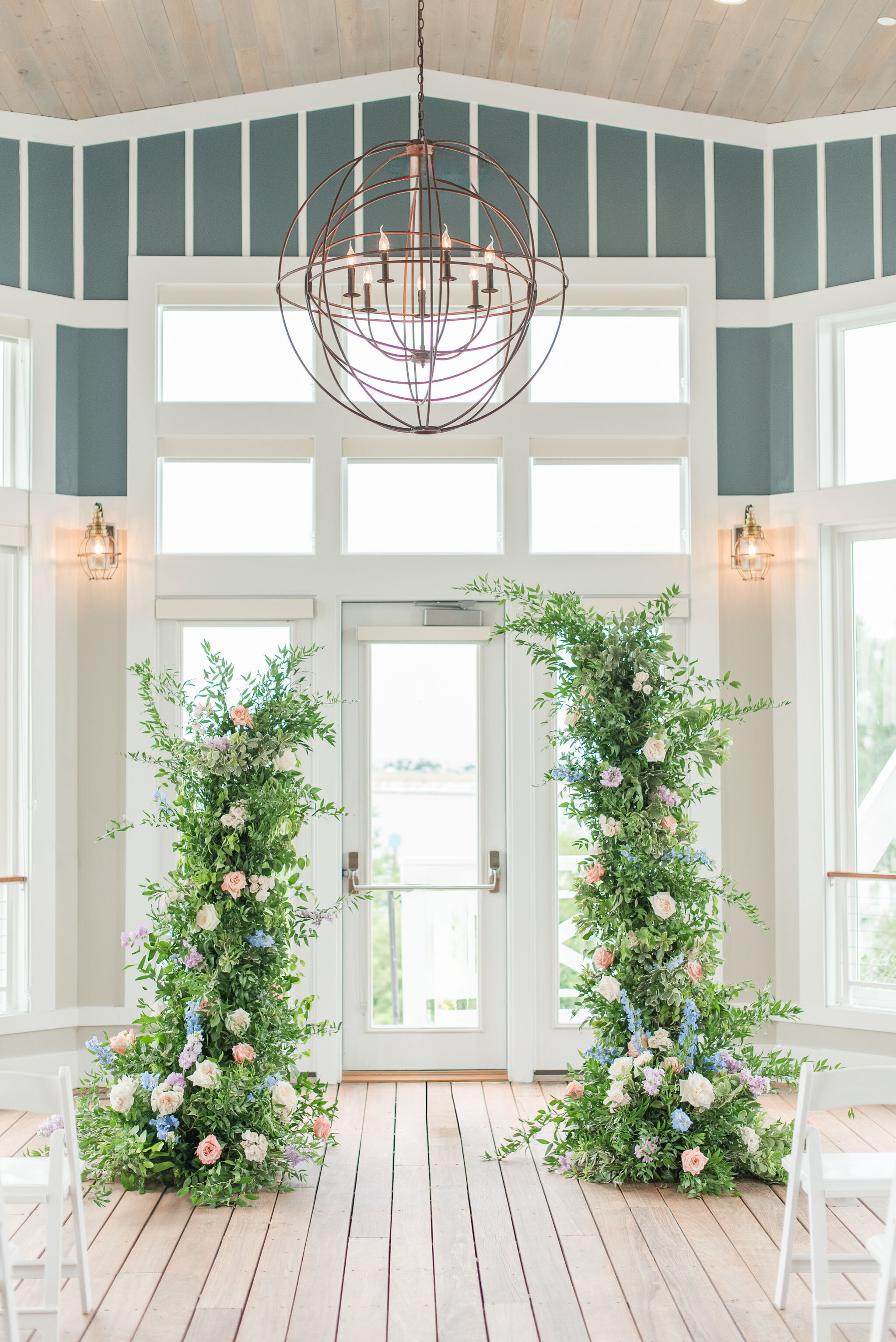 wedding ceremony decor floral arches indoors