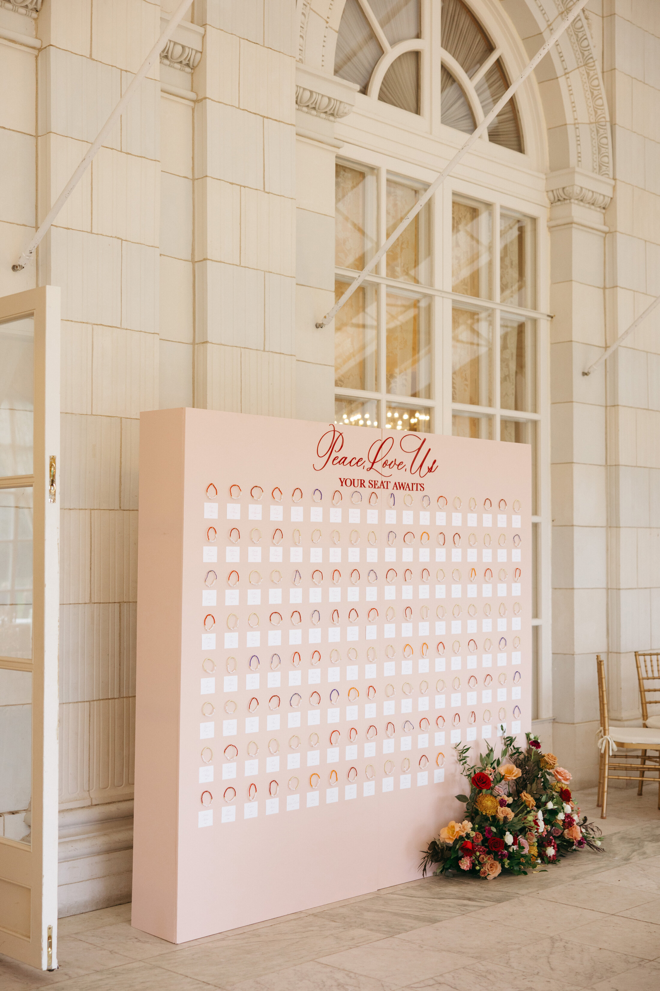 Pink Statement Wall with Friendship Bracelets | Rosecliff Mansion Wedding