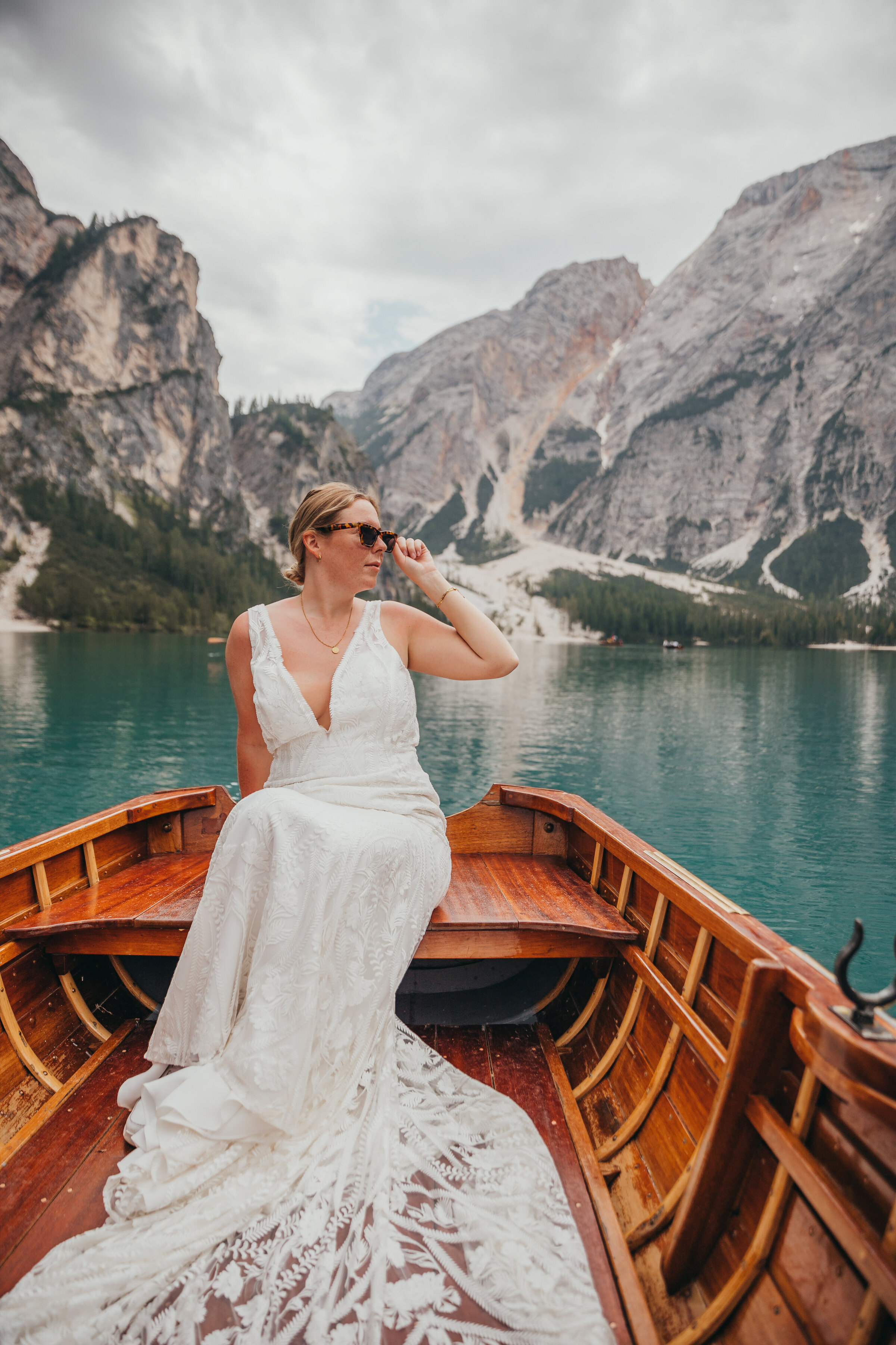 bride on boat in lake poses
