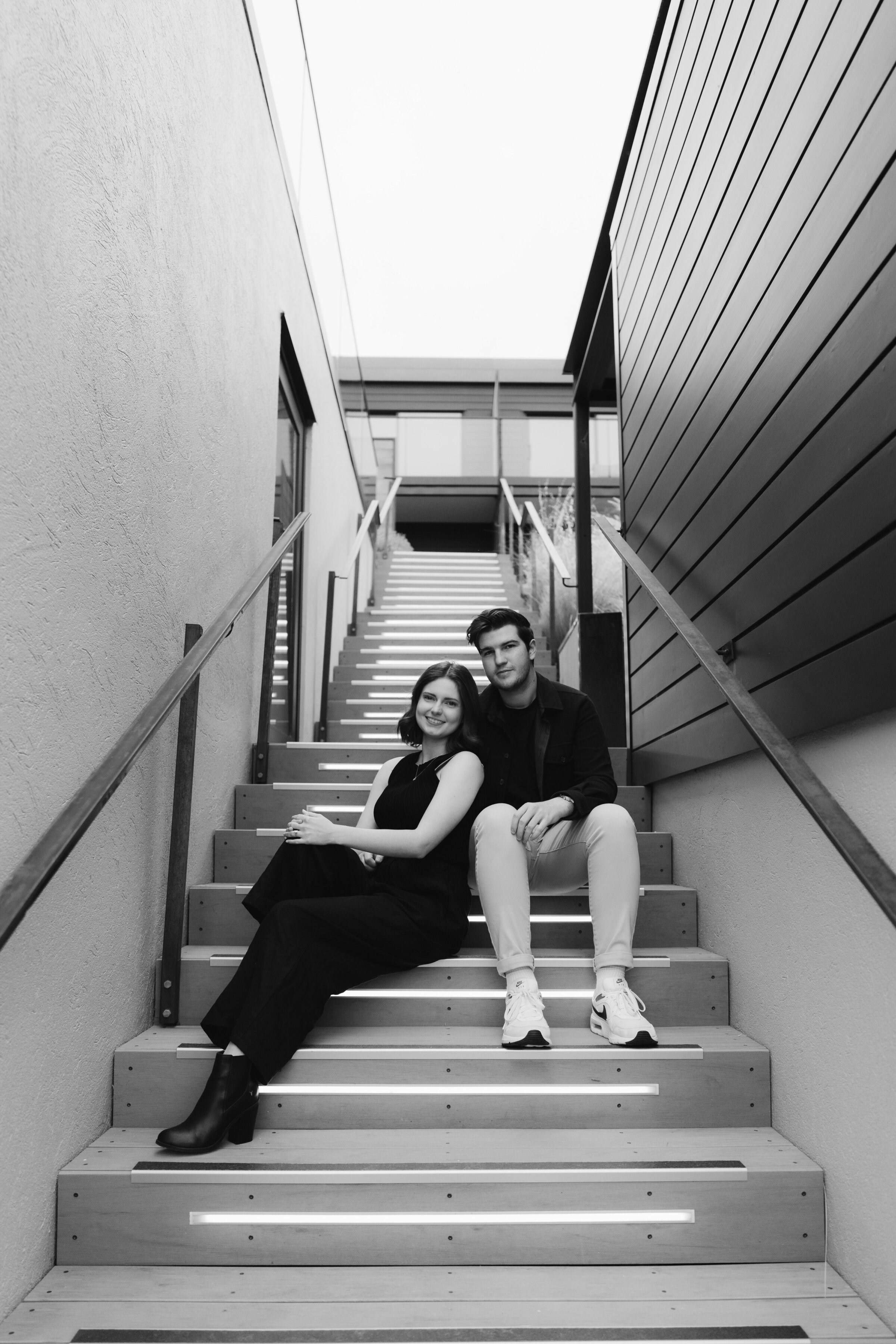 just-engaged-couple-posing-on-hotel-steps