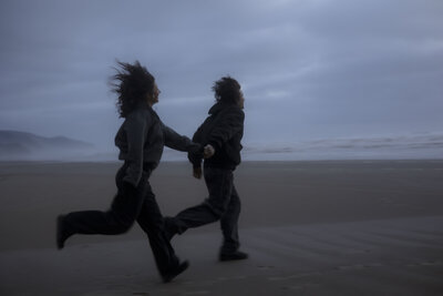 fallback shared on Invalid Date | A couple runs along the coastline during blue hour