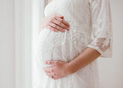 fallback shared on Invalid Date | Pregnant woman embraces her pregnant belly during Maternity Portrait Session in Charlest...