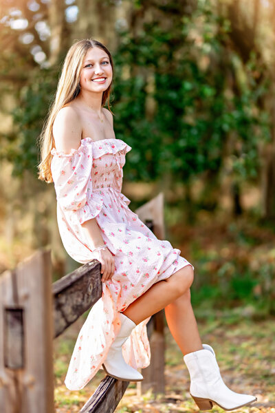 fallback shared on Invalid Date | Stunning senior photos of girl posing on wooden fence in Central Florida. She is wearing...