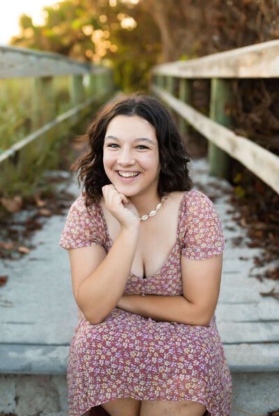 fallback shared on Invalid Date | Beautiful senior photography of senior girl at Cocoa Beach in Florida smiling with one h...