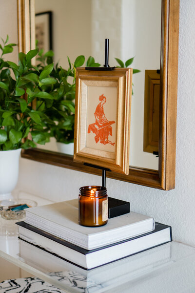 rebekah nicole interiors vintage asian art with a candle and plant
