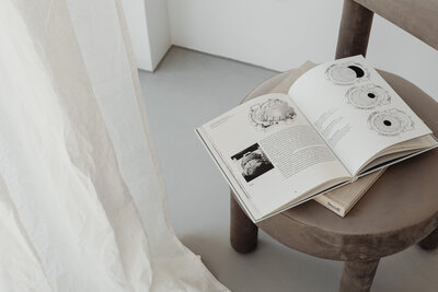 kaboompics_grey-beige-upholstered-dining-chair-open-books-greige-26608